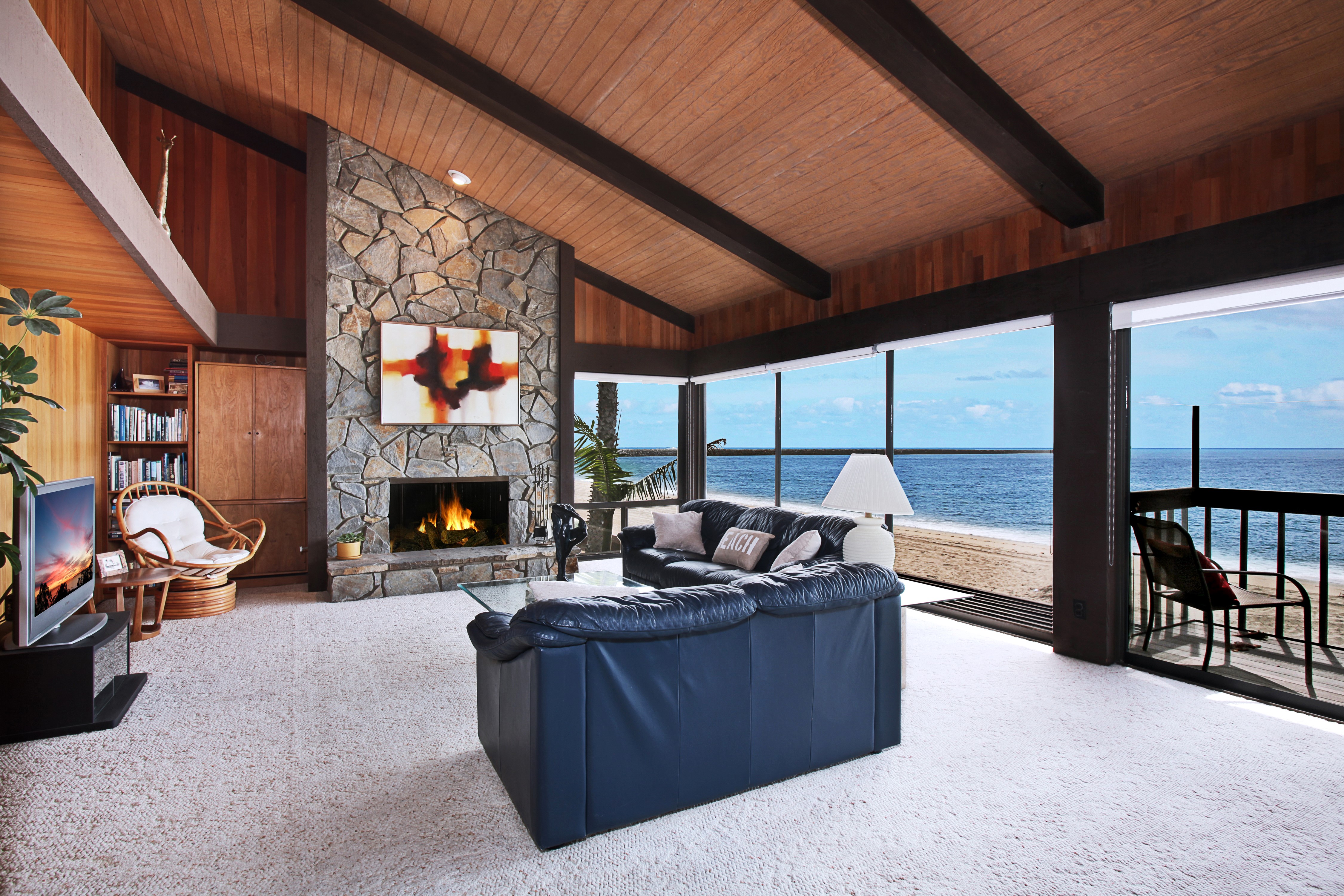 Living room with fireplace and ocean view HD Wallpaper