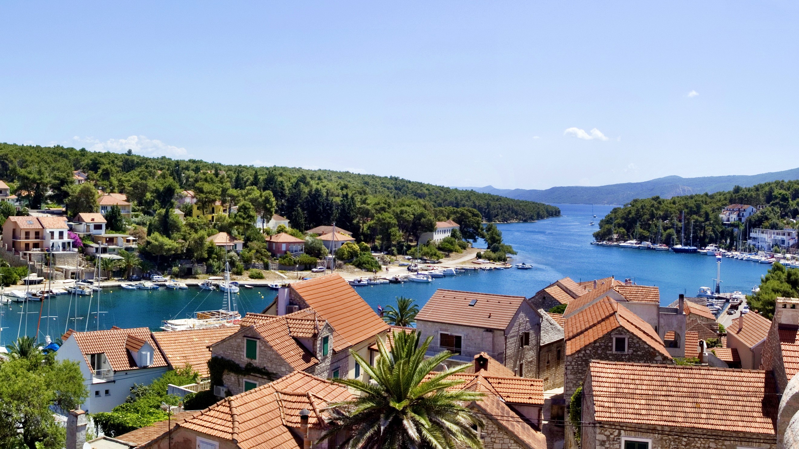 Coastal village with red-tiled roofs and boats in Croatia HD Wallpaper
