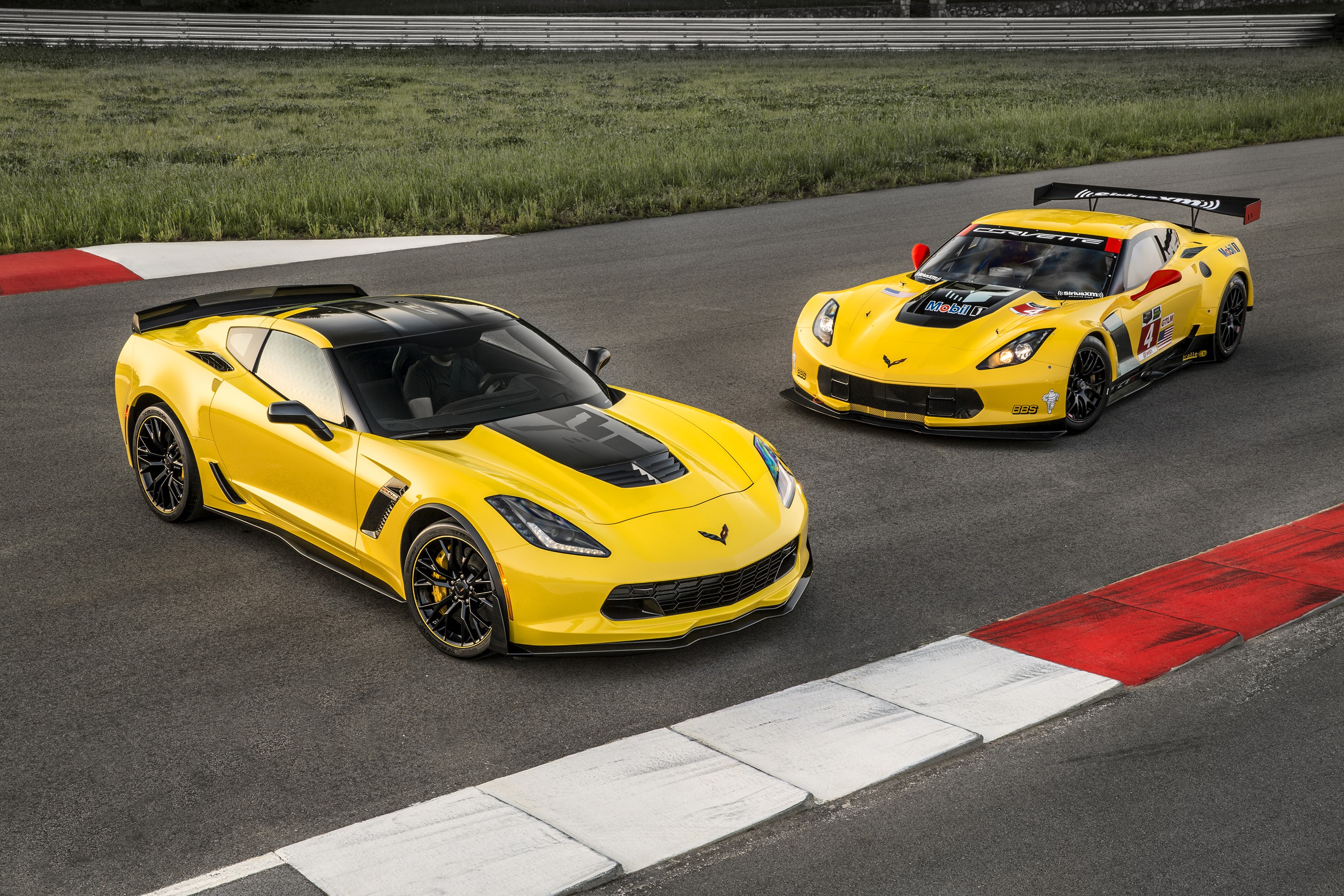 Two yellow Chevrolet Corvette C7 race cars on a track HD Wallpaper