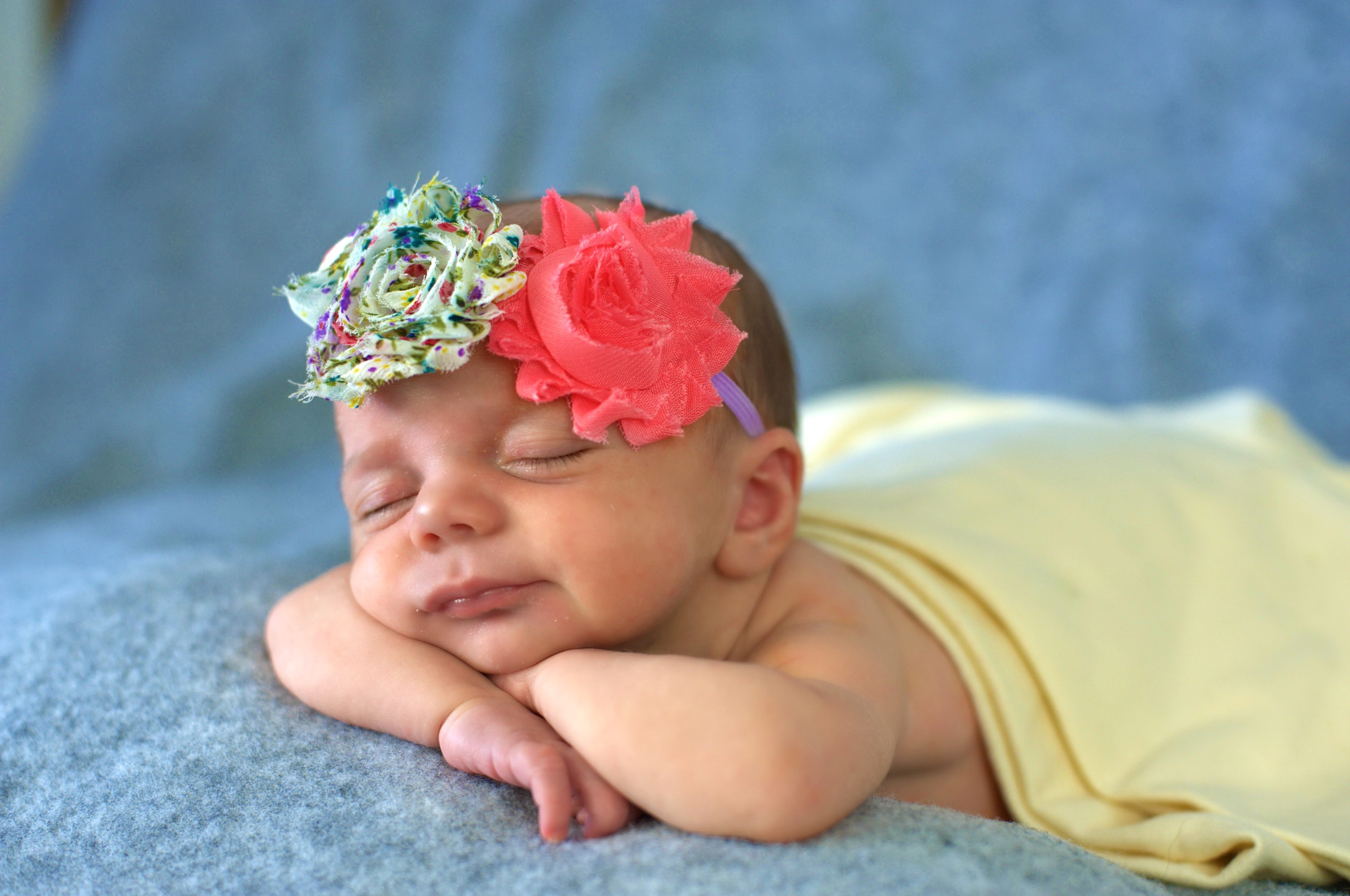 Newborn baby girl sleeping with flower headband HD Wallpaper