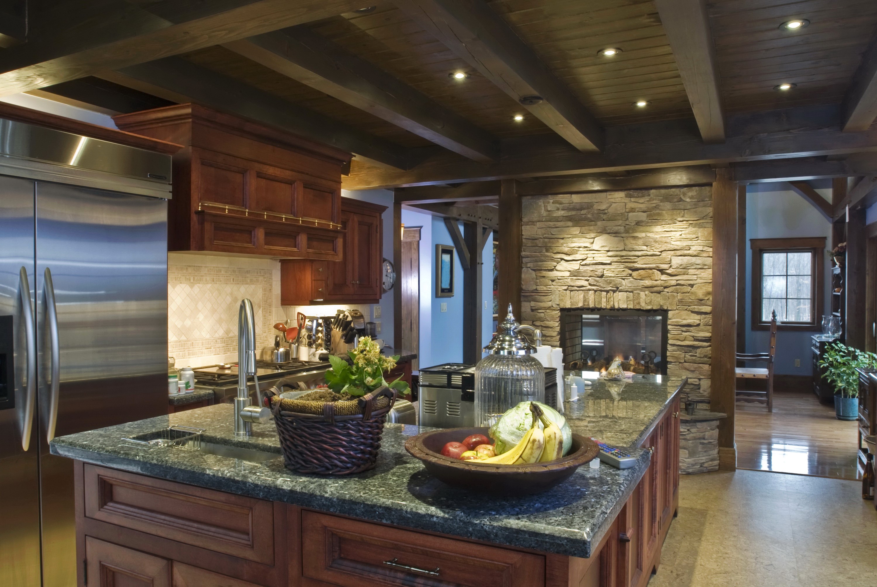 Rustic kitchen with stone fireplace and island HD Wallpaper