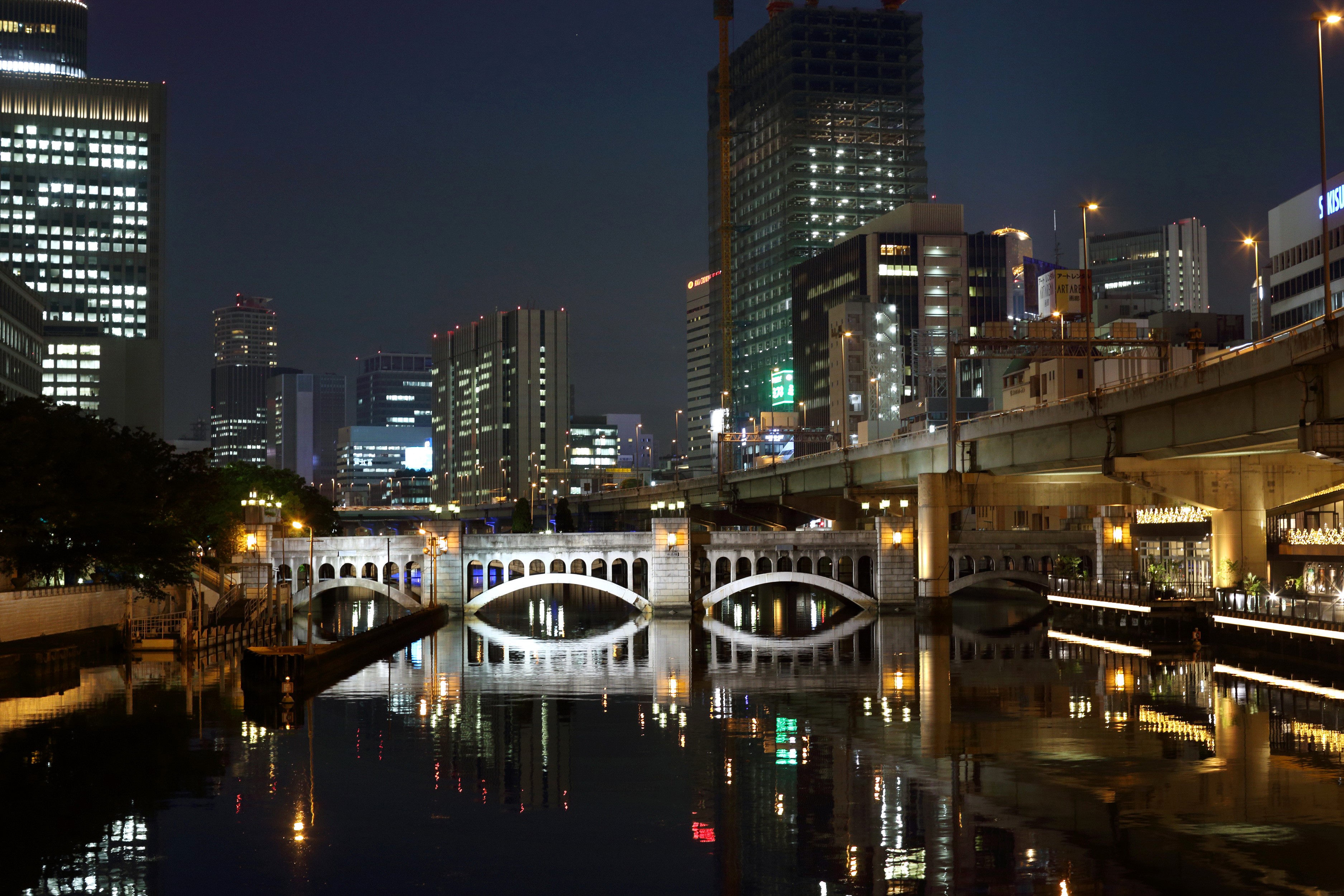 Cityscape at Night with Bridges and River Reflections HD Wallpaper