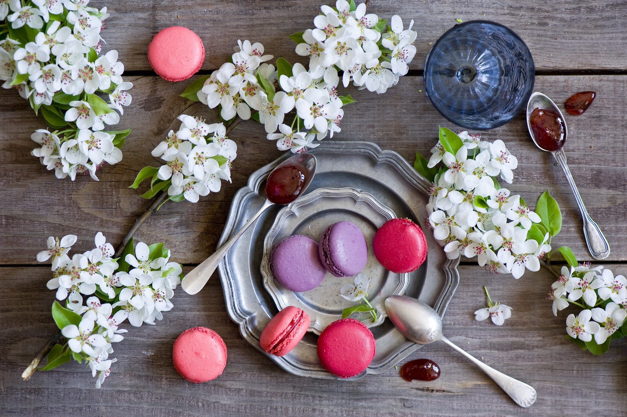 Macarons and flowering branches on a wooden table HD Wallpaper