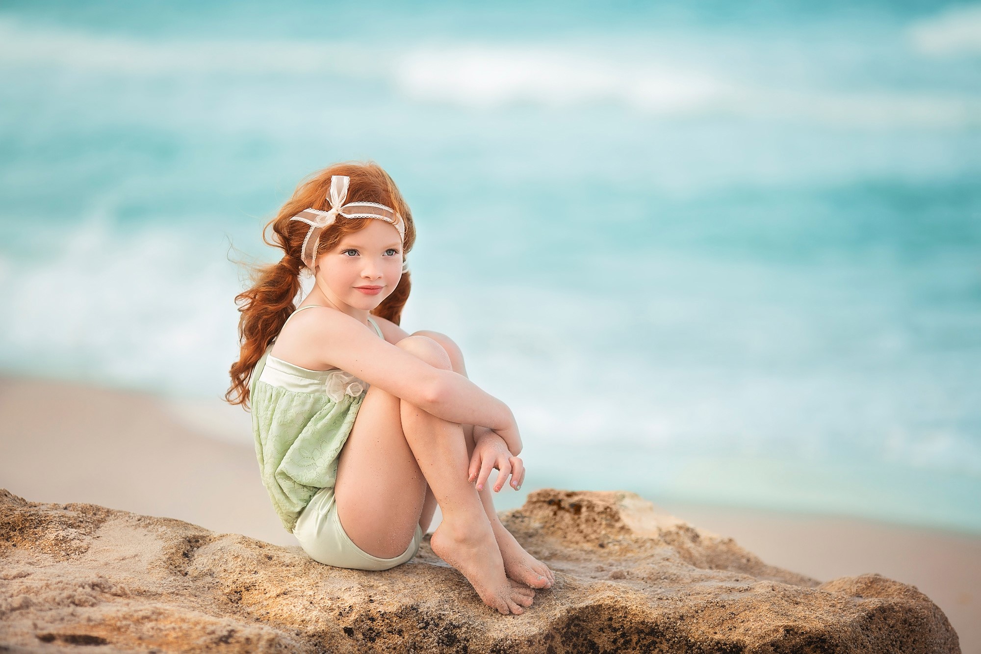 Redhead Girl Sitting on Rocky Beach Near the Sea HD Wallpaper