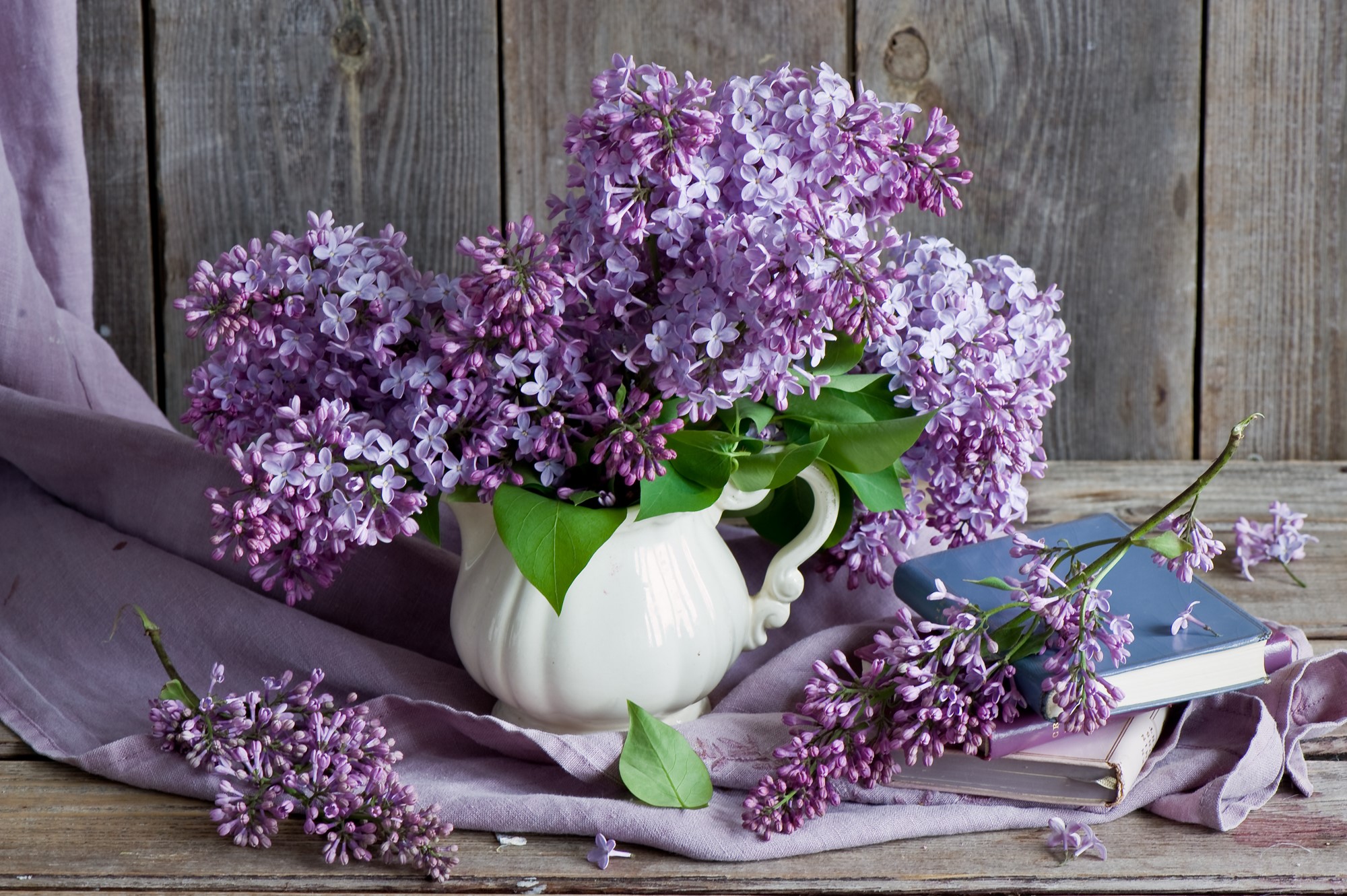 Lilac flowers in a jug with books HD Wallpaper