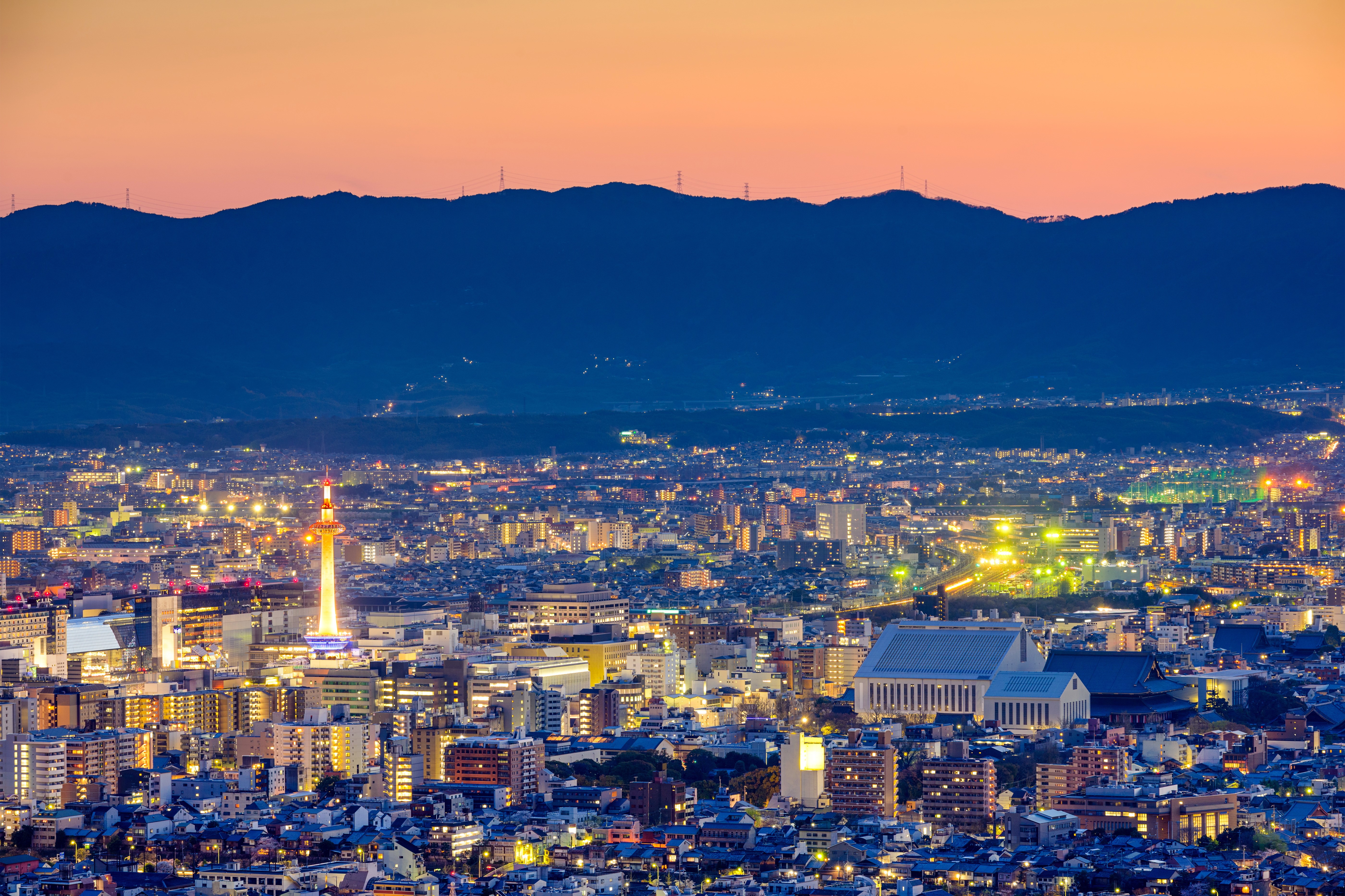 Kyoto cityscape at dusk with mountains HD Wallpaper