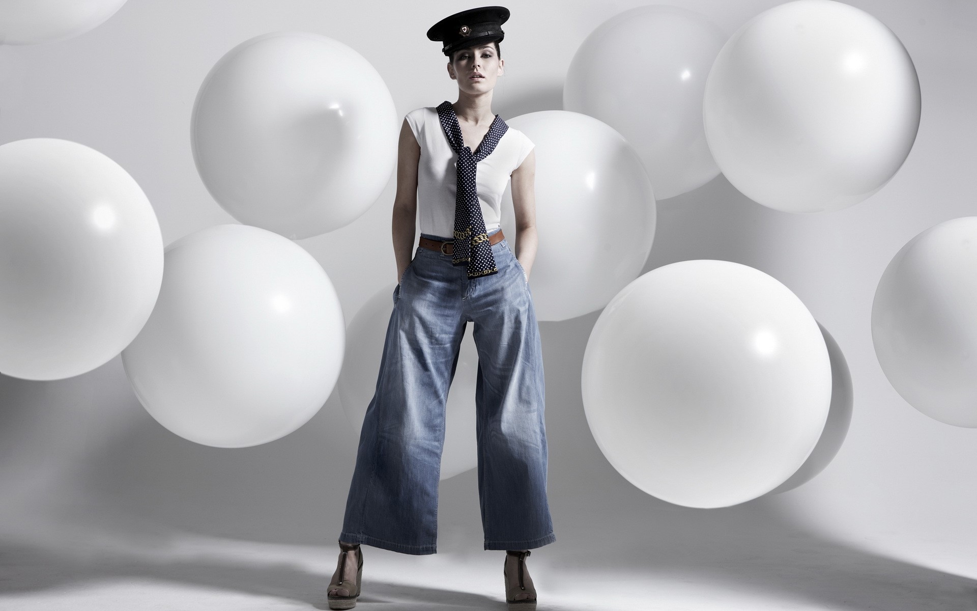 Woman in hat and wide-leg jeans with white balls HD Wallpaper