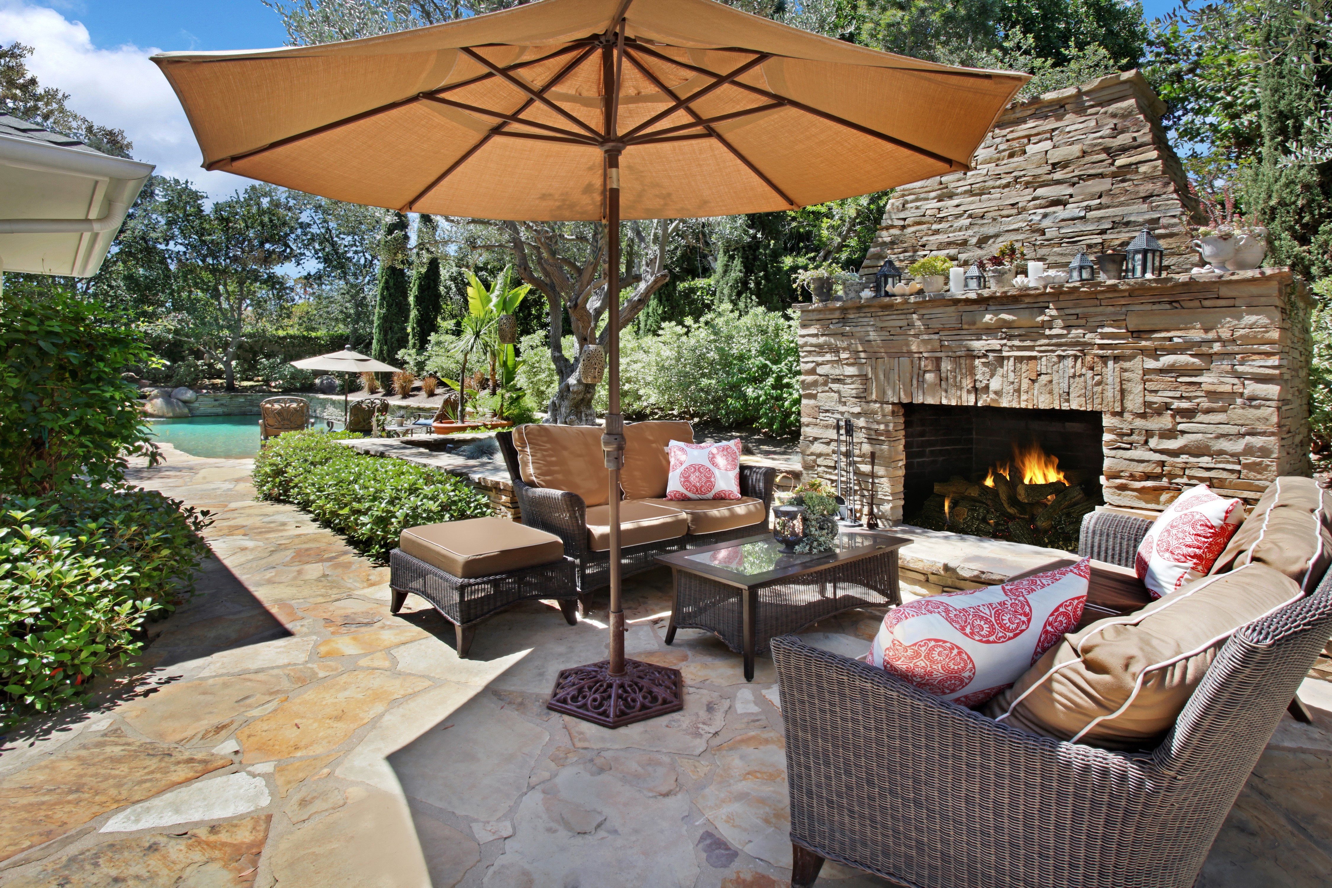 Outdoor Living Area with Fireplace and Pool HD Wallpaper
