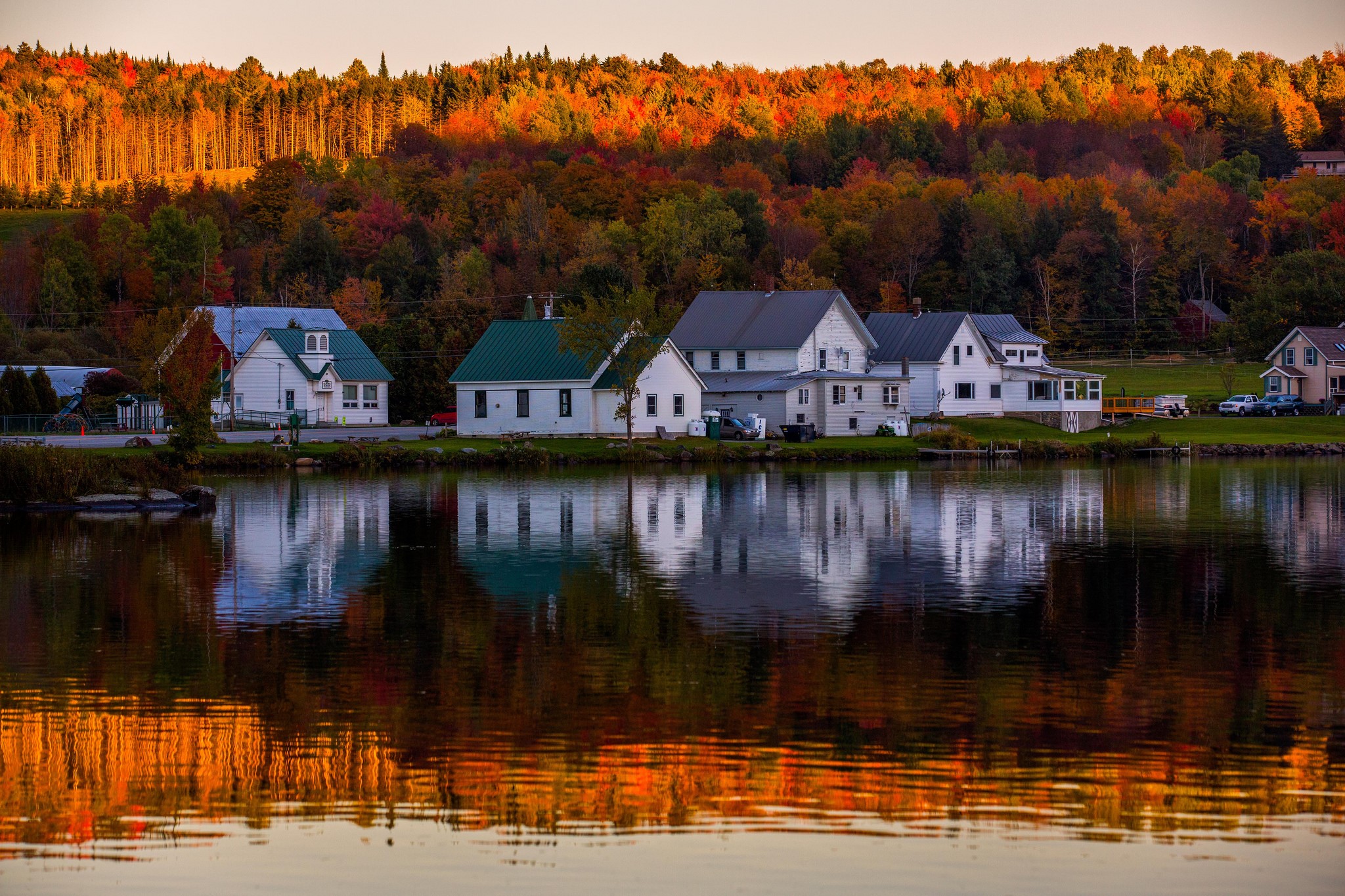 Houses by a lake during autumn sunset HD Wallpaper