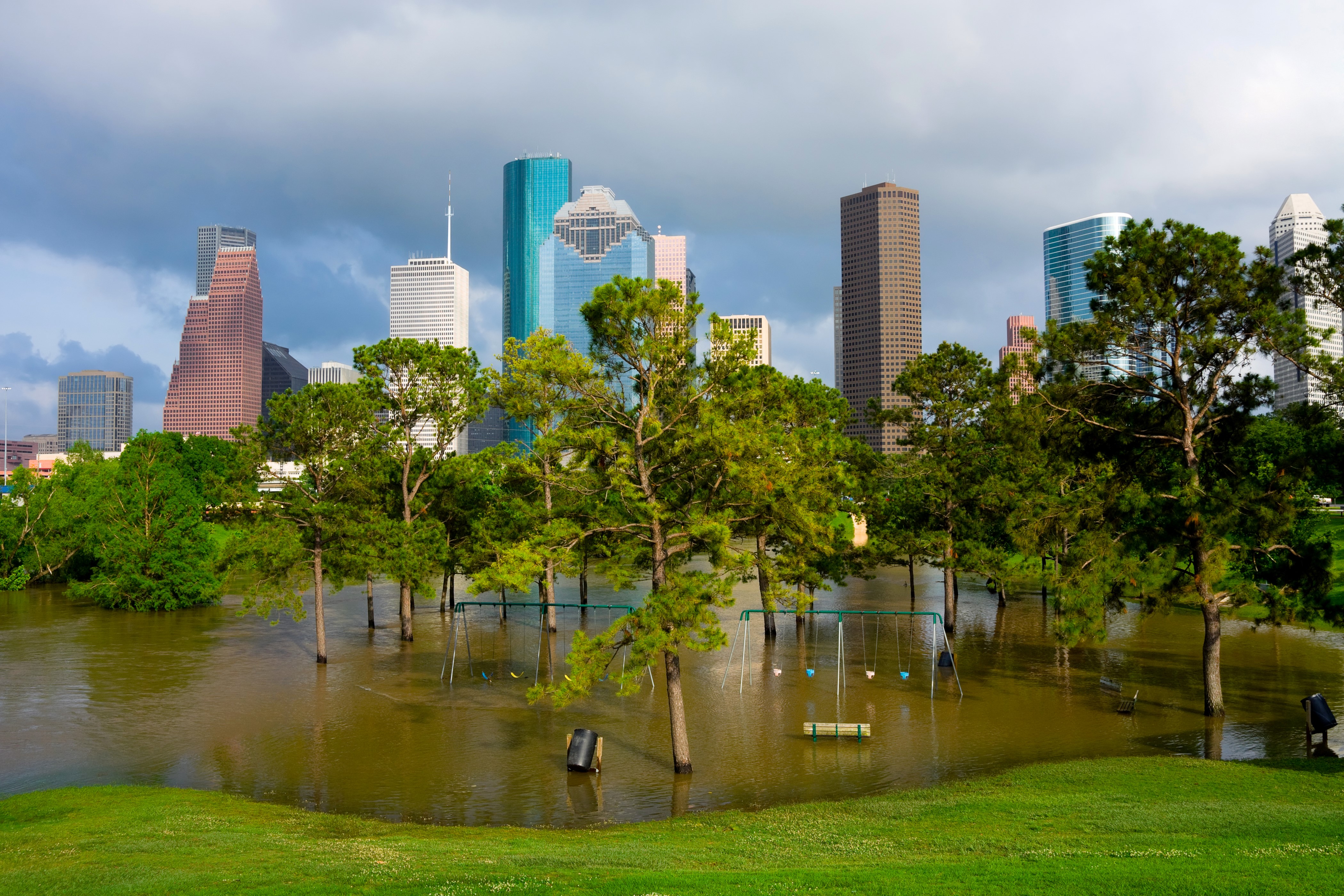 Houston skyscrapers and flooded park with swings HD Wallpaper