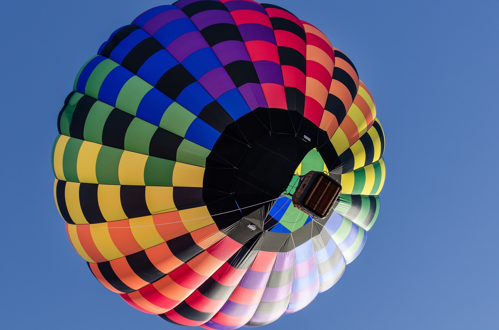Hot air balloon with colorful panels against blue sky HD Wallpaper