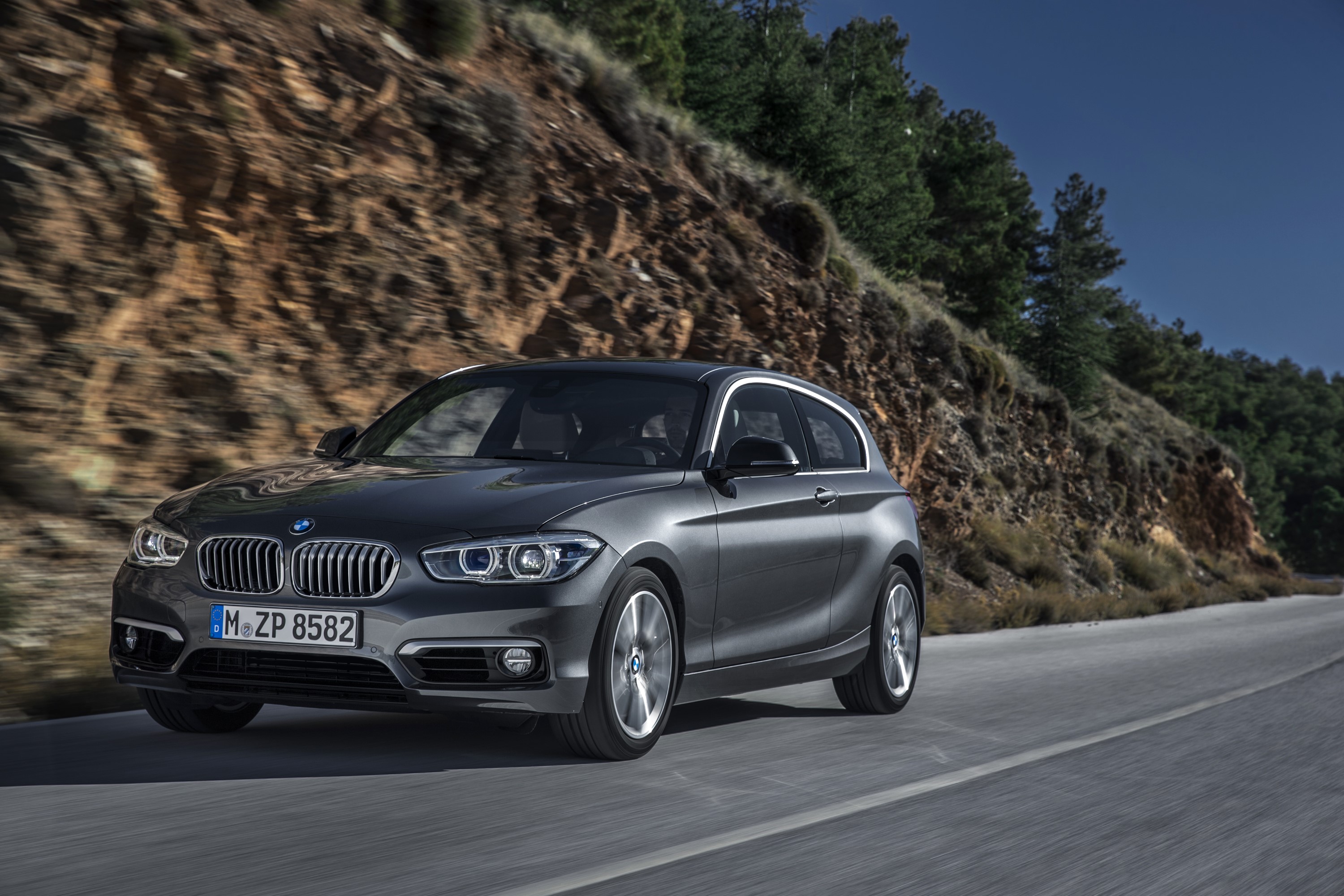 2015 BMW 120d Urban Line driving on a road HD Wallpaper