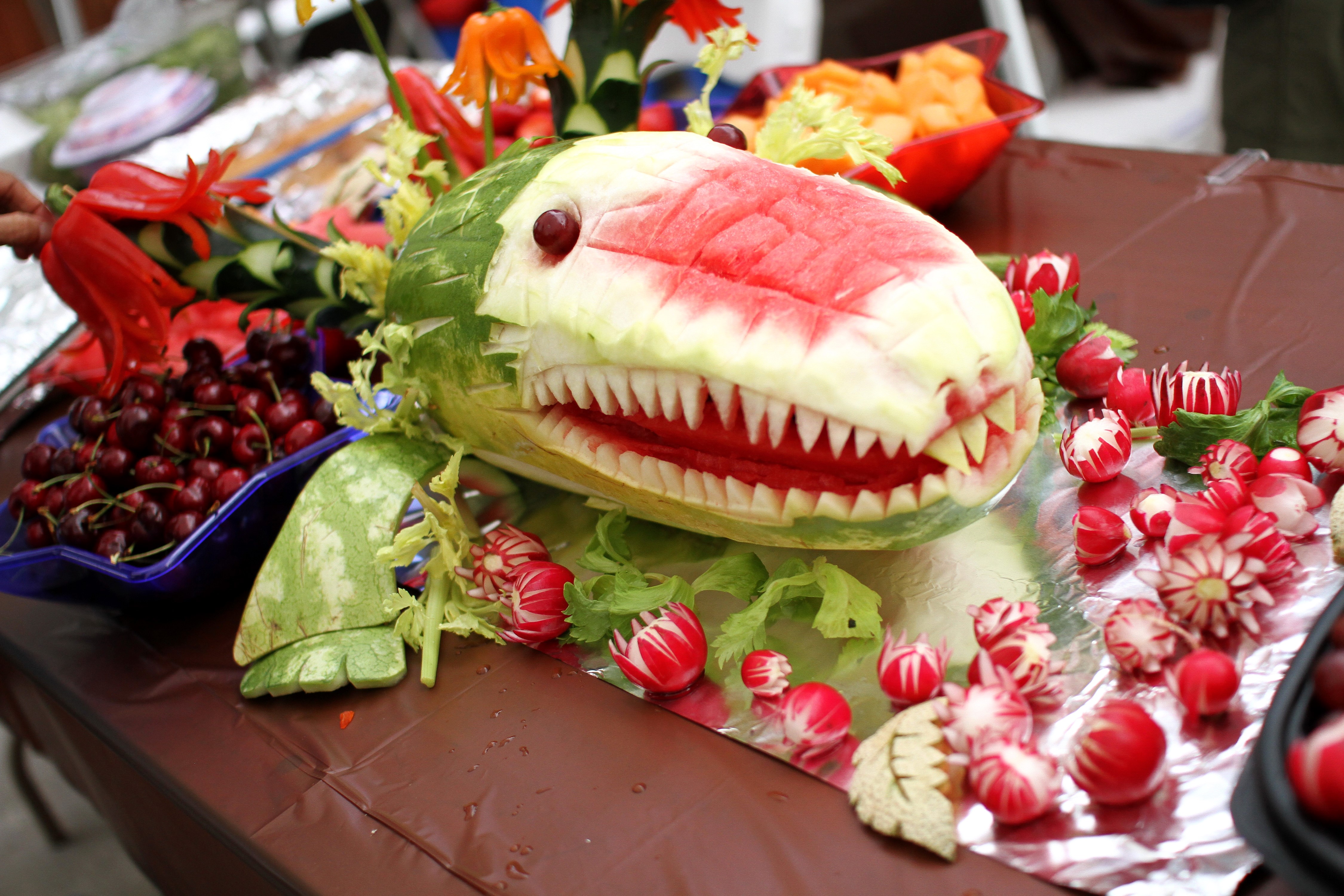 Watermelon carved into a shark with cherries and radishes HD Wallpaper