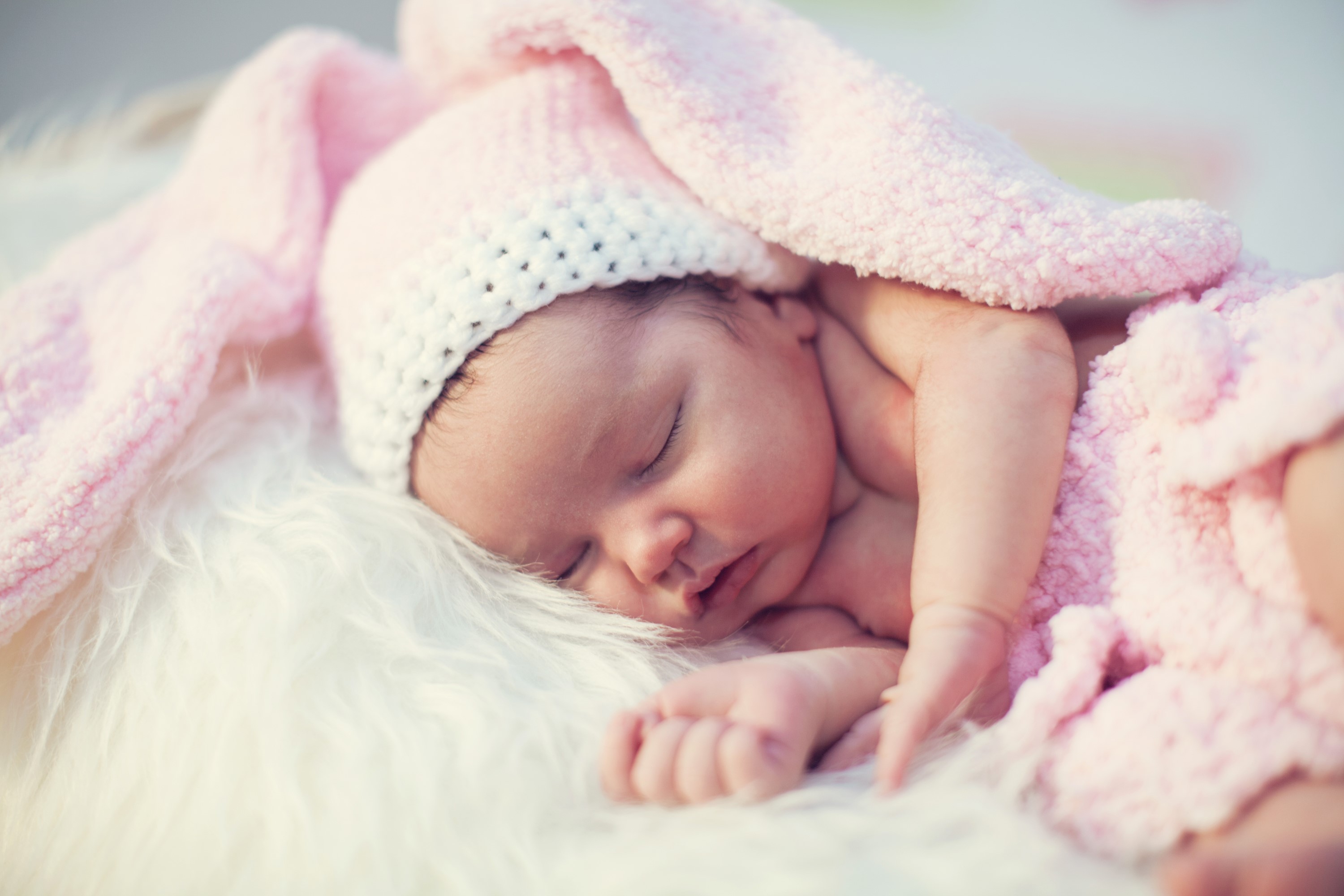 Newborn baby sleeping in a pink bunny hat HD Wallpaper