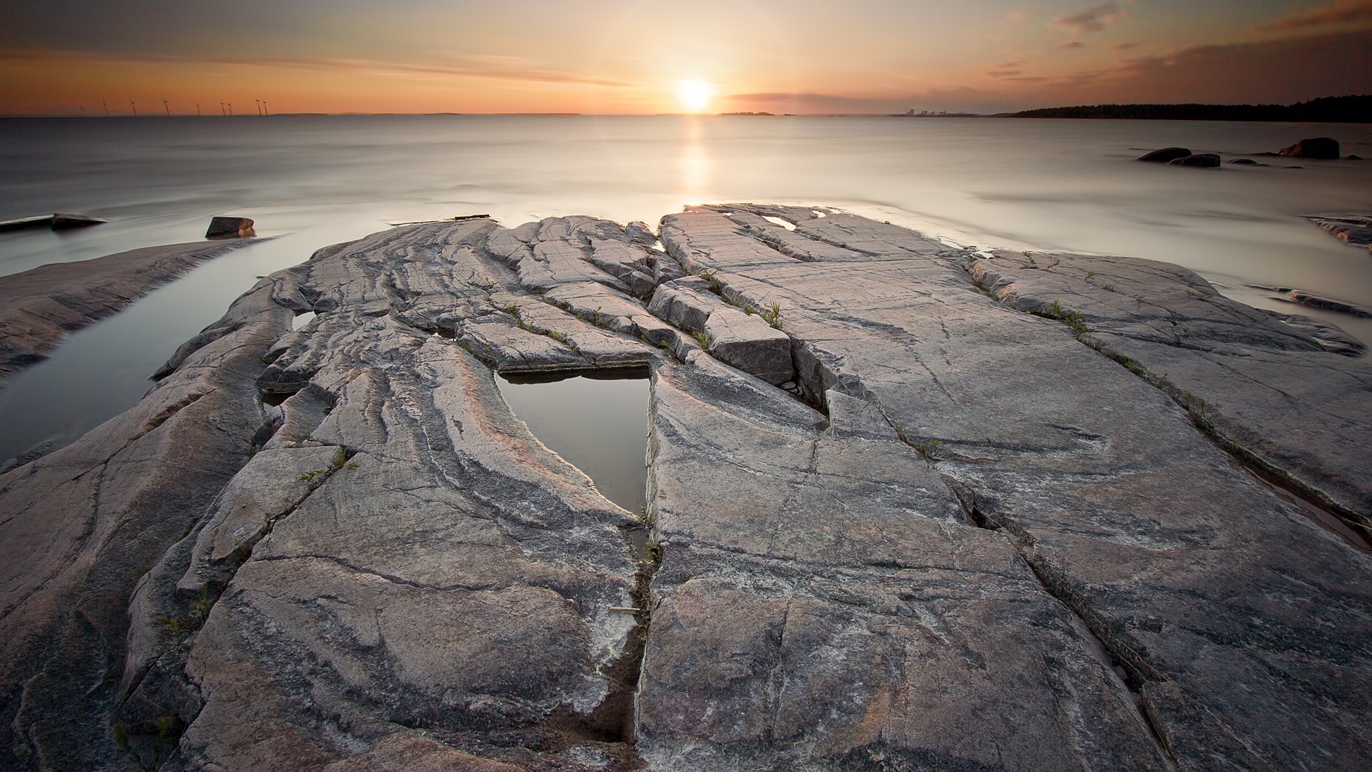 Rocky Shoreline at Sunset with Calm Water HD Wallpaper