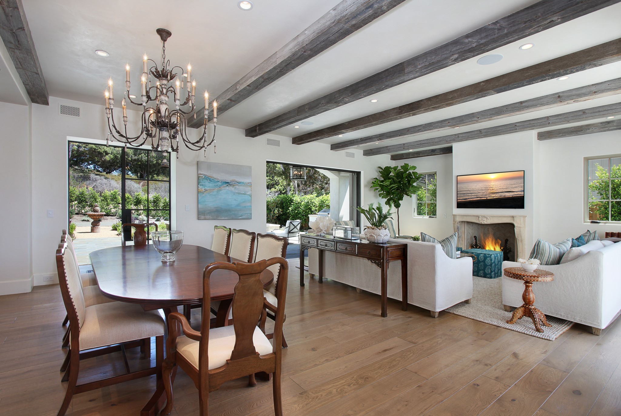 Dining room and living room with fireplace and chandelier HD Wallpaper