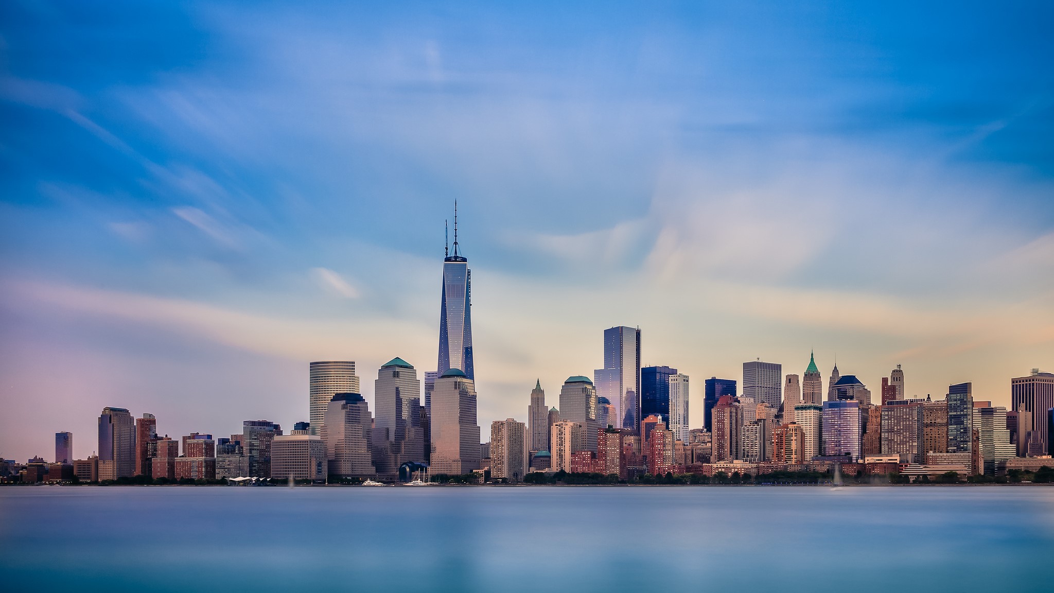 New York City skyline with One World Trade Center over water HD Wallpaper