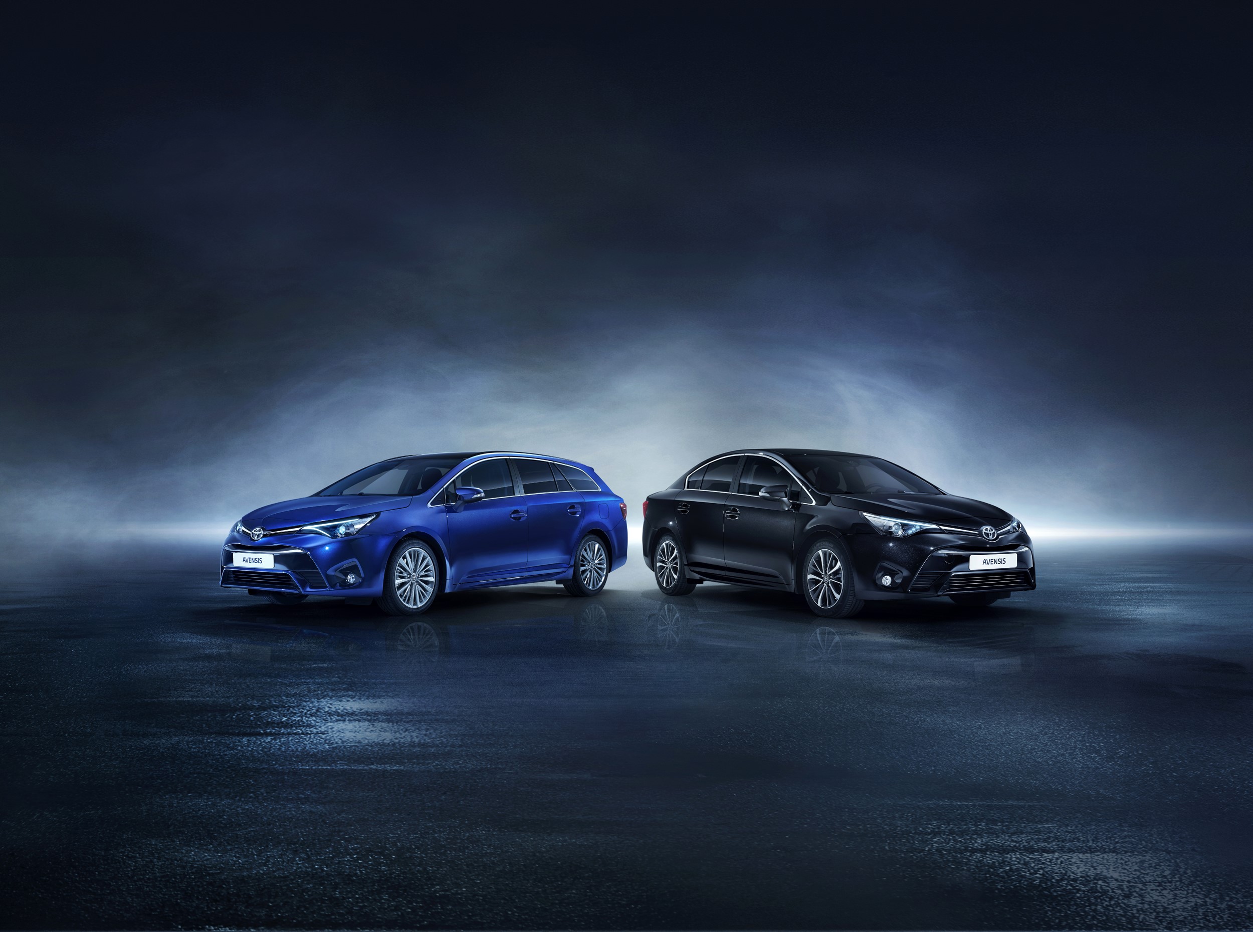 Two Toyota Avensis cars, one blue wagon and one black sedan HD Wallpaper
