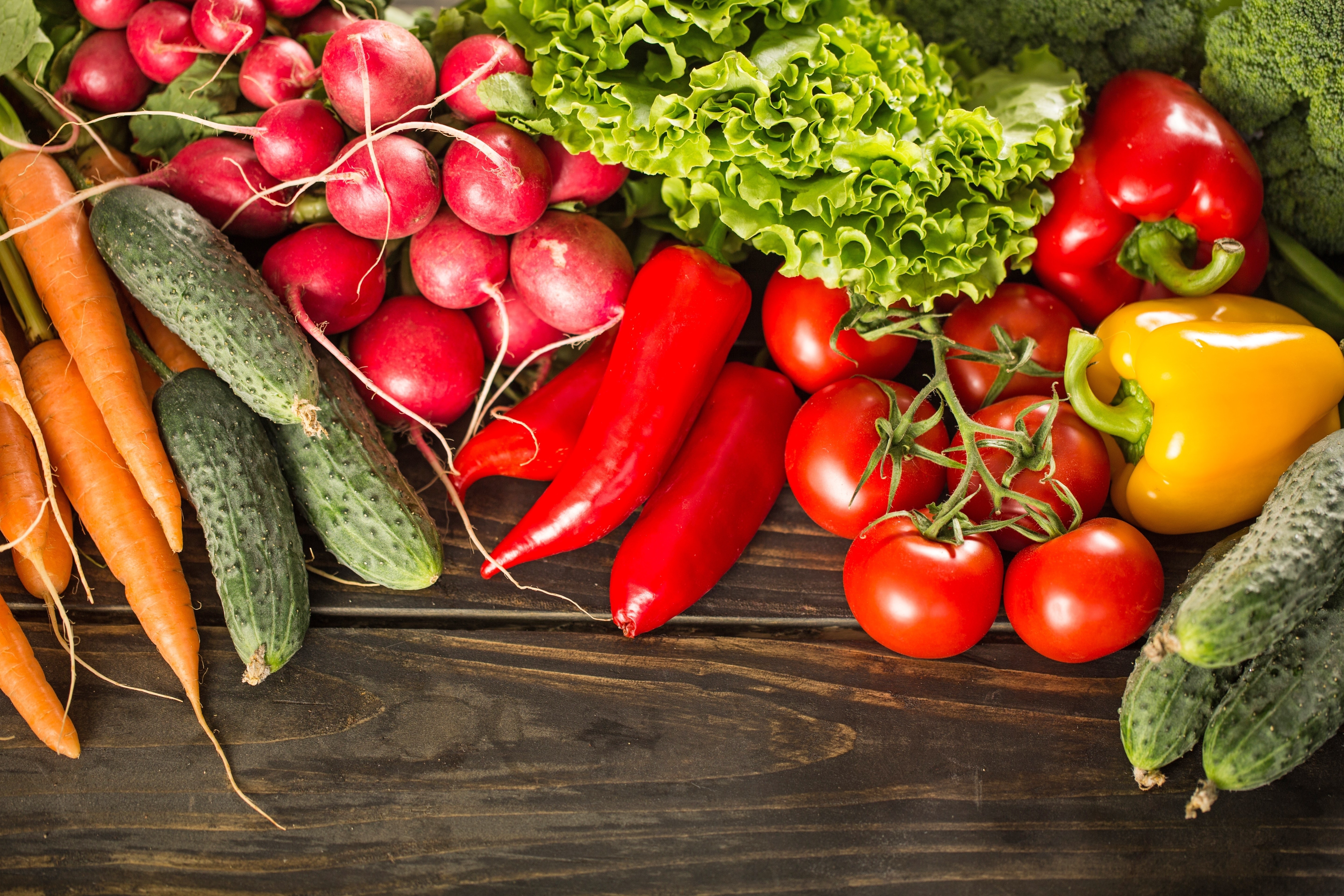Assortment of fresh vegetables including tomatoes, peppers, cucumbers, carrots, and radishes HD Wallpaper