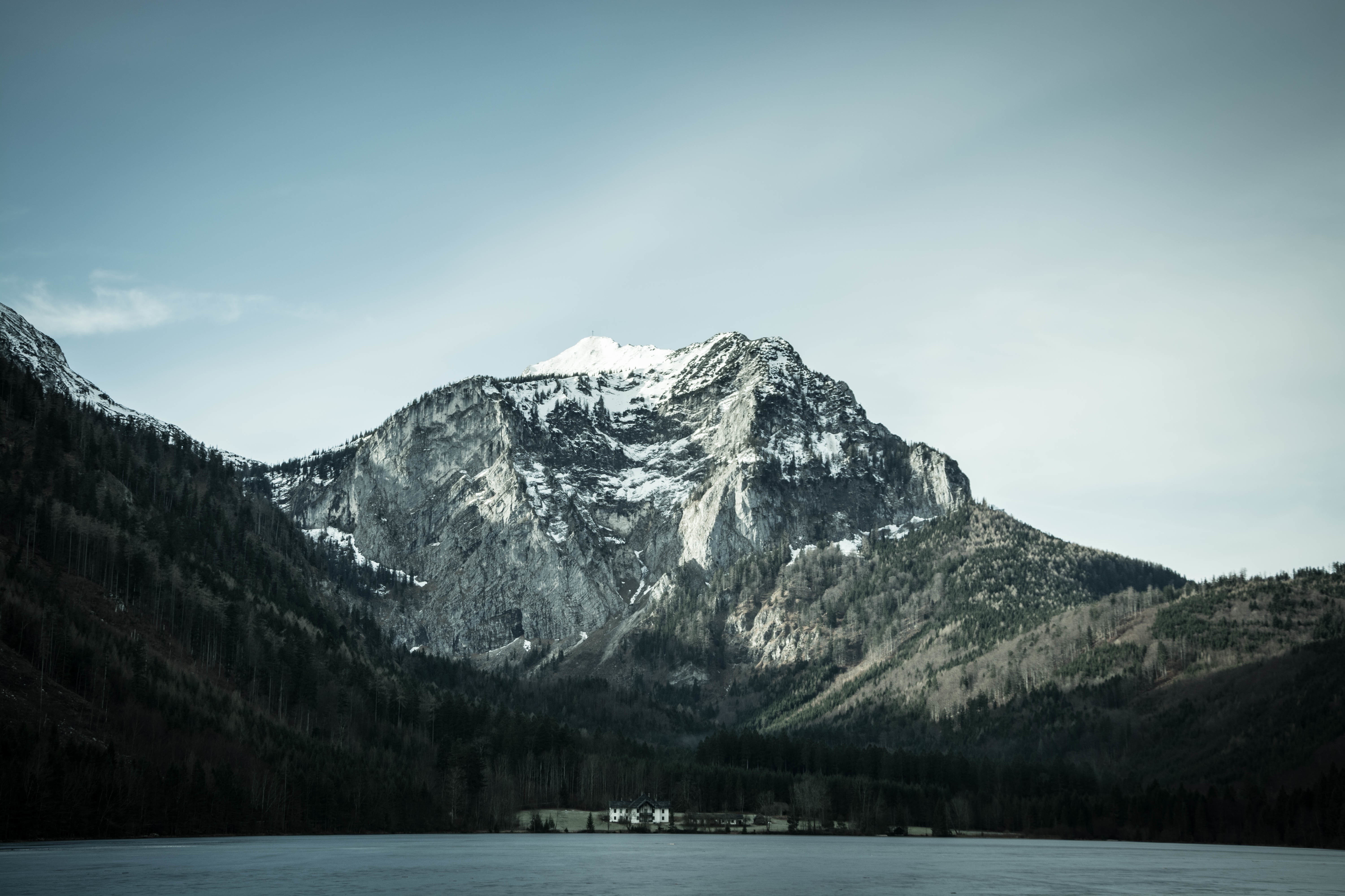 Snow-capped mountains over a frozen lake HD Wallpaper