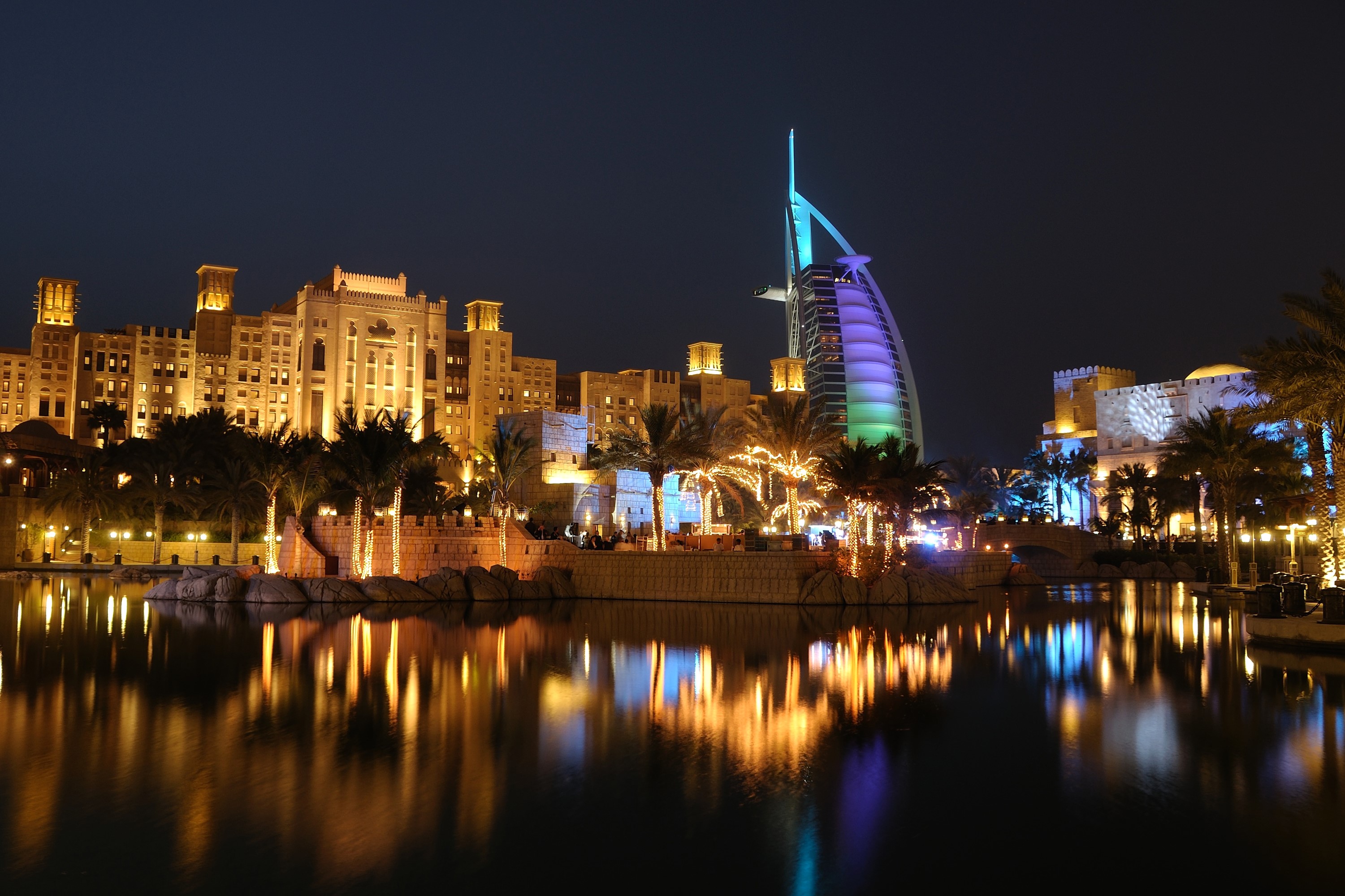 Burj Al Arab hotel at night with reflections in water HD Wallpaper