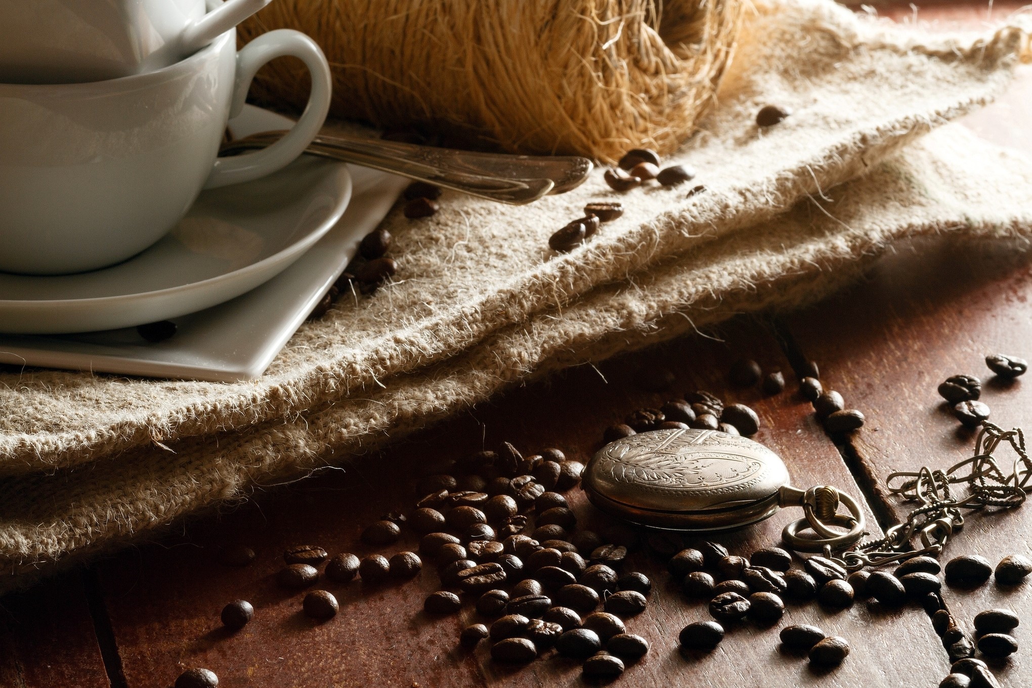 Coffee beans, cup, and pocket watch on burlap HD Wallpaper