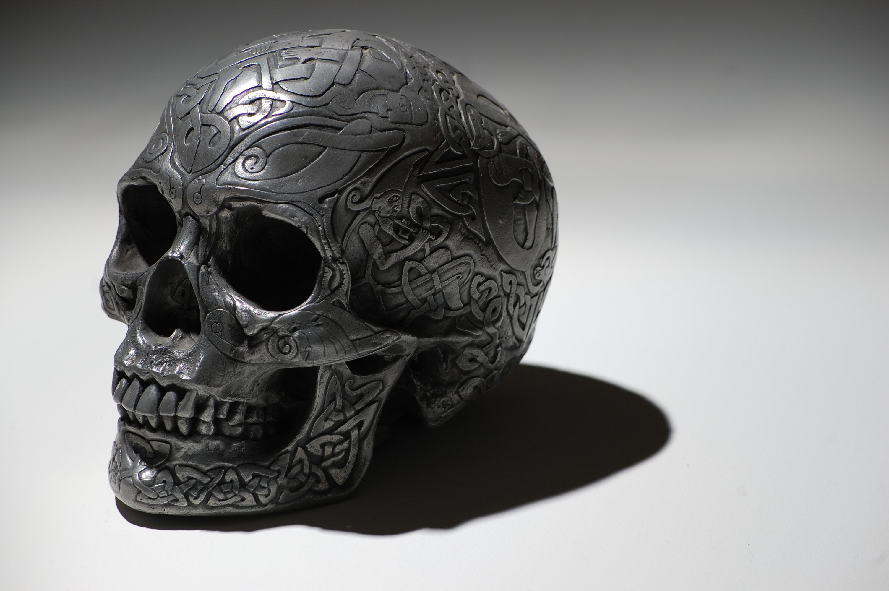 Close-up of a decorative skull with Celtic knotwork HD Wallpaper
