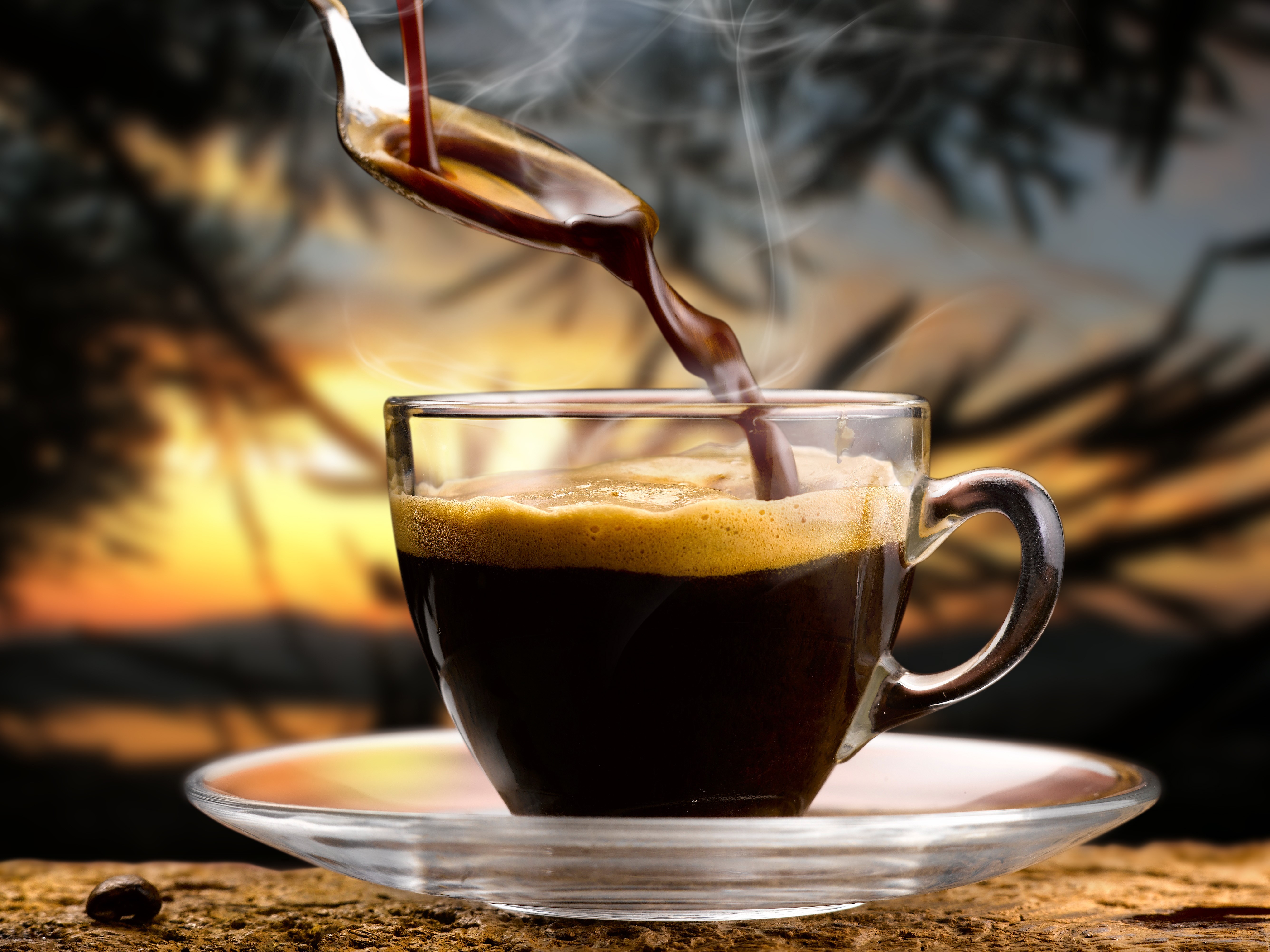 Coffee being poured into a cup with steam HD Wallpaper