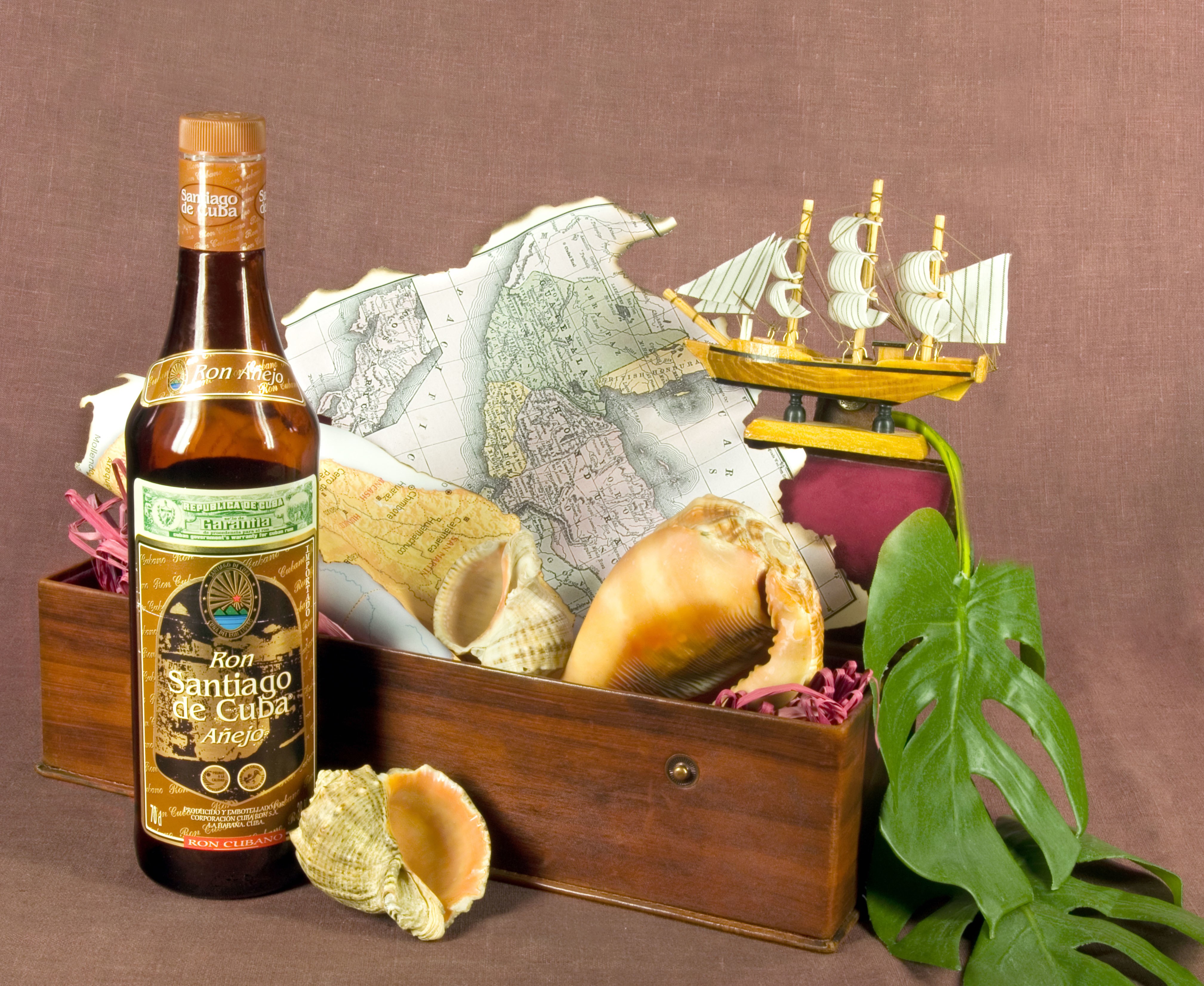 Ron Santiago de Cuba Anejo Bottle with Seashells and Map HD Wallpaper