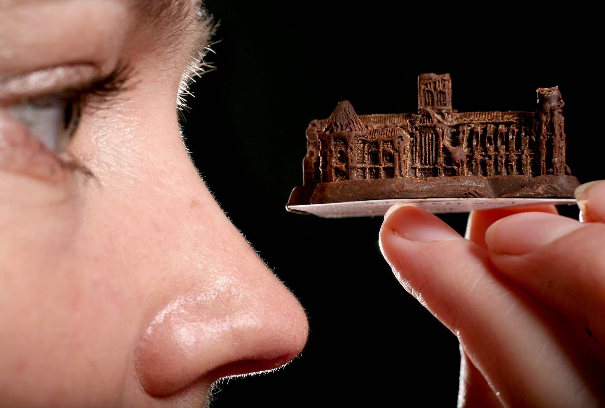 Person holding a miniature chocolate castle HD Wallpaper