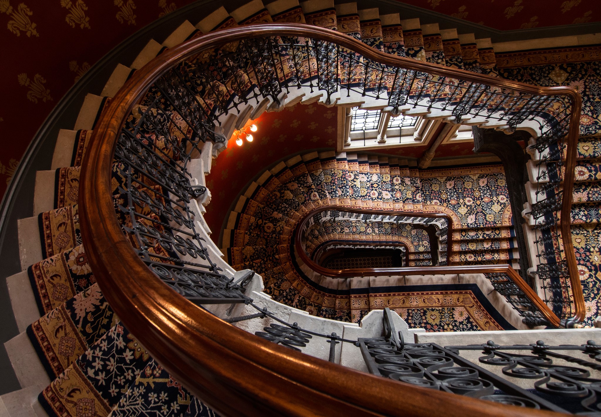 Ornate Spiral Staircase with Persian Rugs HD Wallpaper