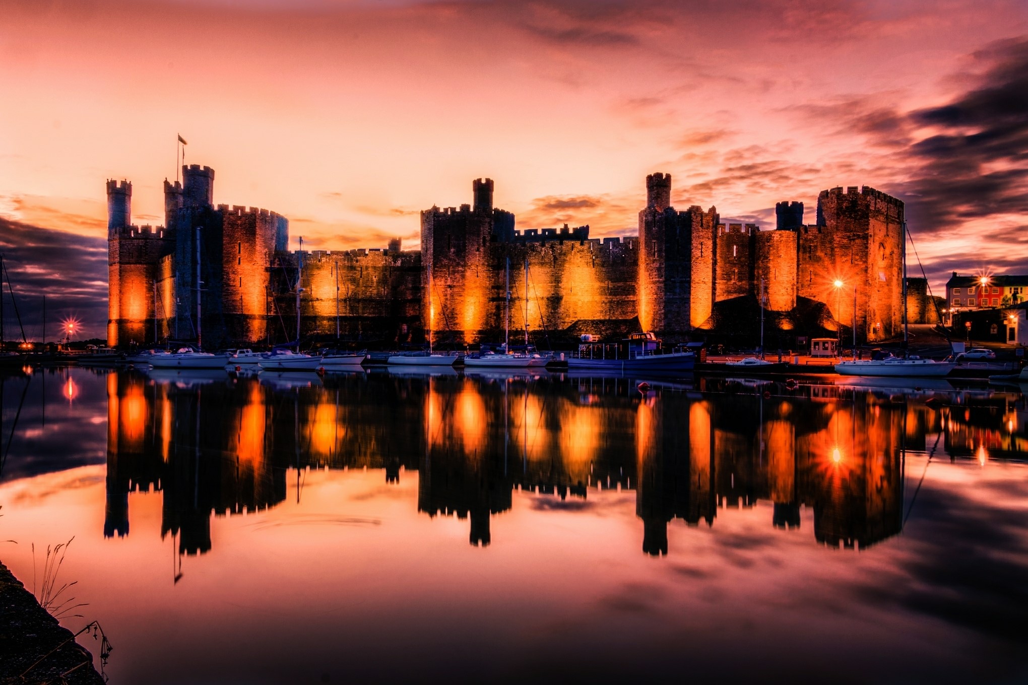 Caernarfon Castle at sunset reflected in water HD Wallpaper