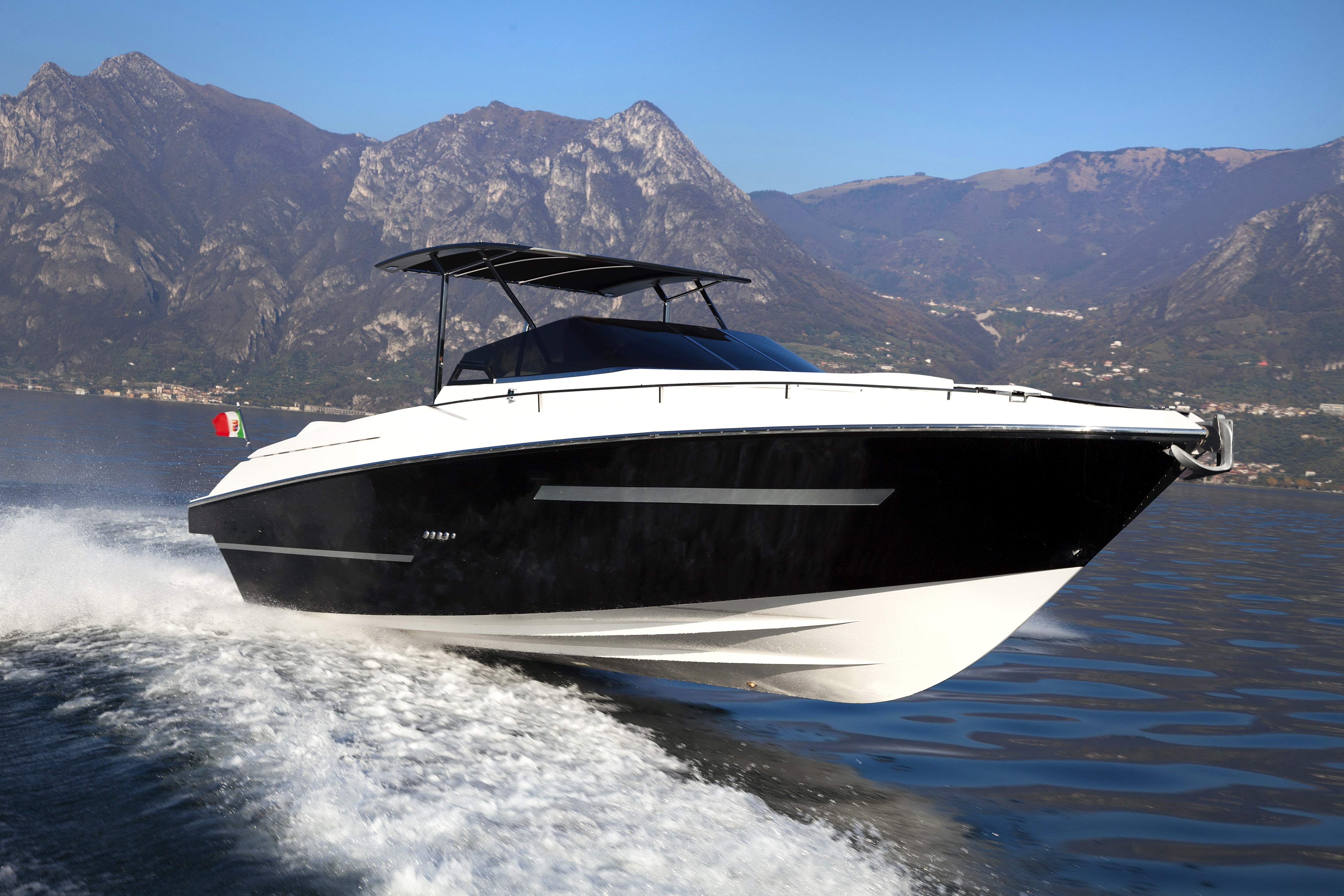 Black and white yacht on a lake with mountains HD Wallpaper