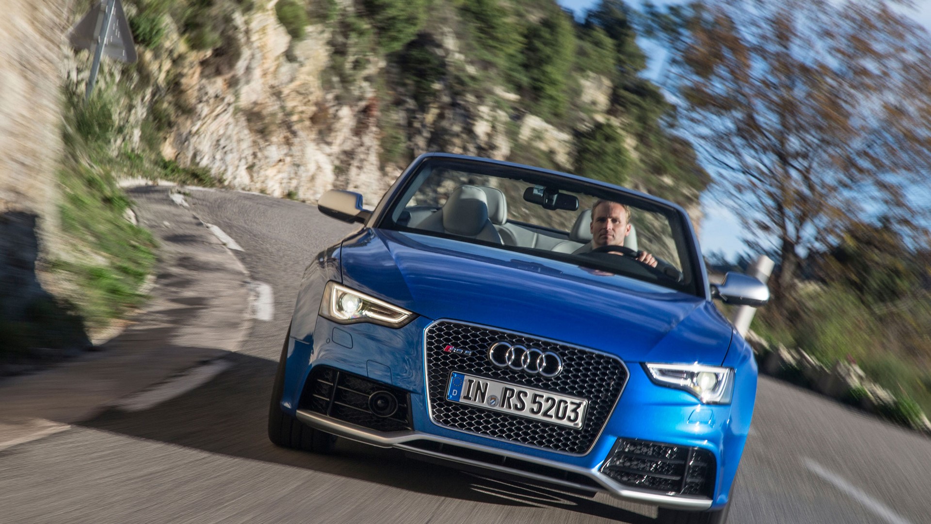 Blue Audi RS 5 Cabriolet driving on a winding road HD Wallpaper