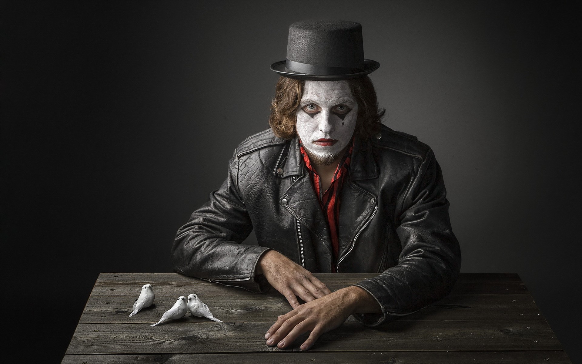Man with clown makeup and top hat with birds HD Wallpaper