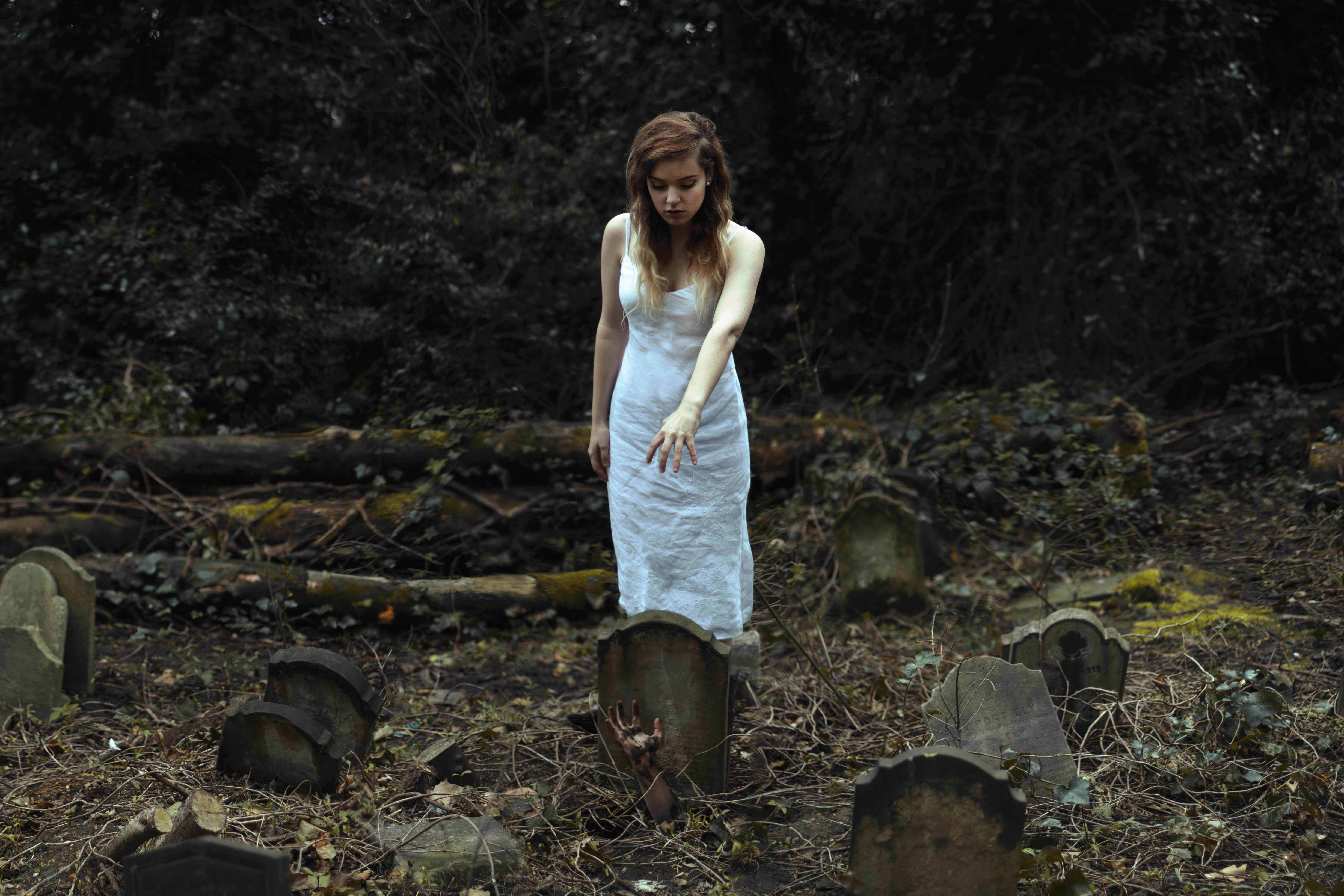Woman in white dress in a cemetery HD Wallpaper