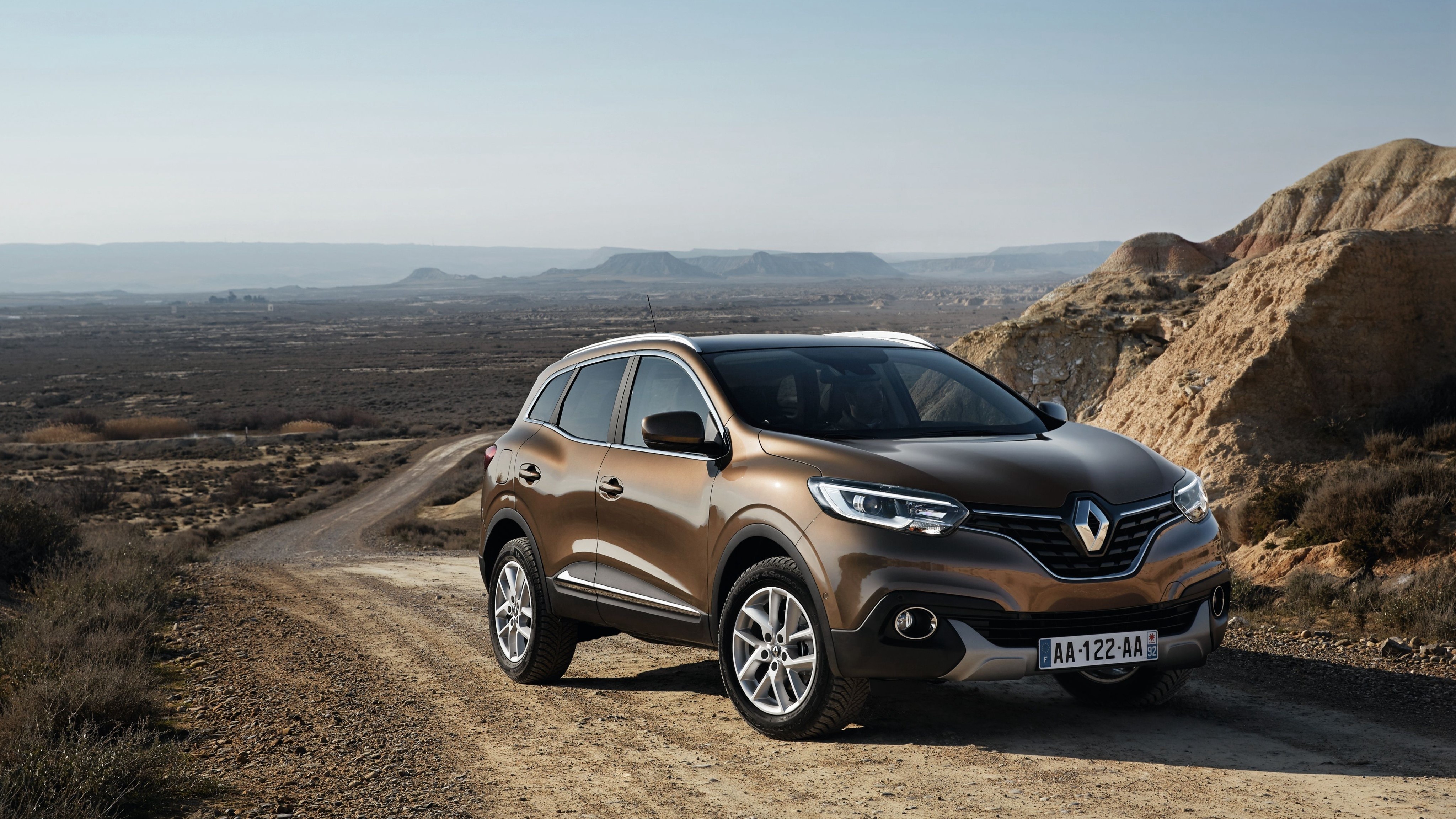Renault Kadjar on a dirt road in a desert landscape HD Wallpaper