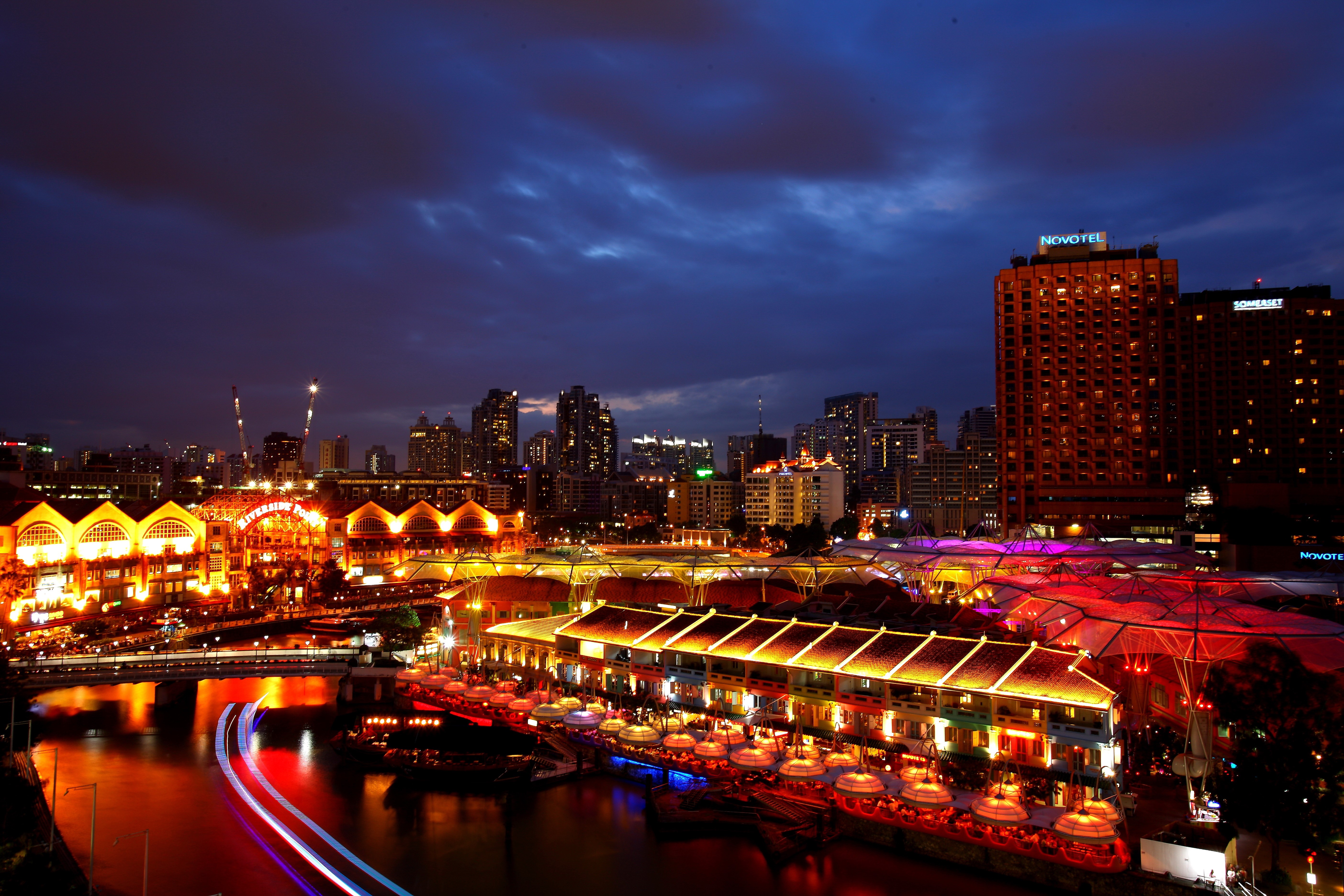 Singapore skyline at night with river and buildings HD Wallpaper