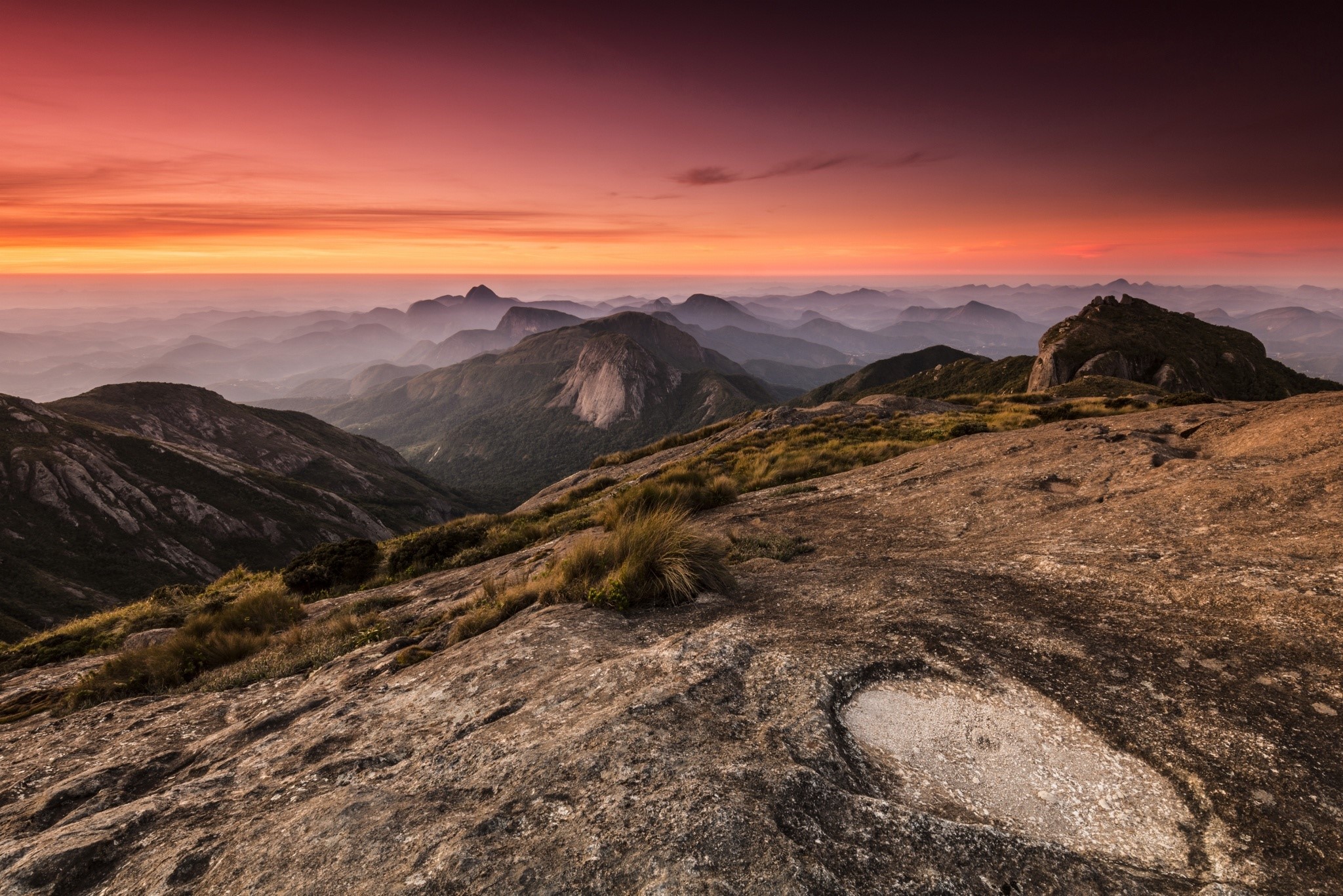 Mountains during sunrise or sunset with hazy layers HD Wallpaper