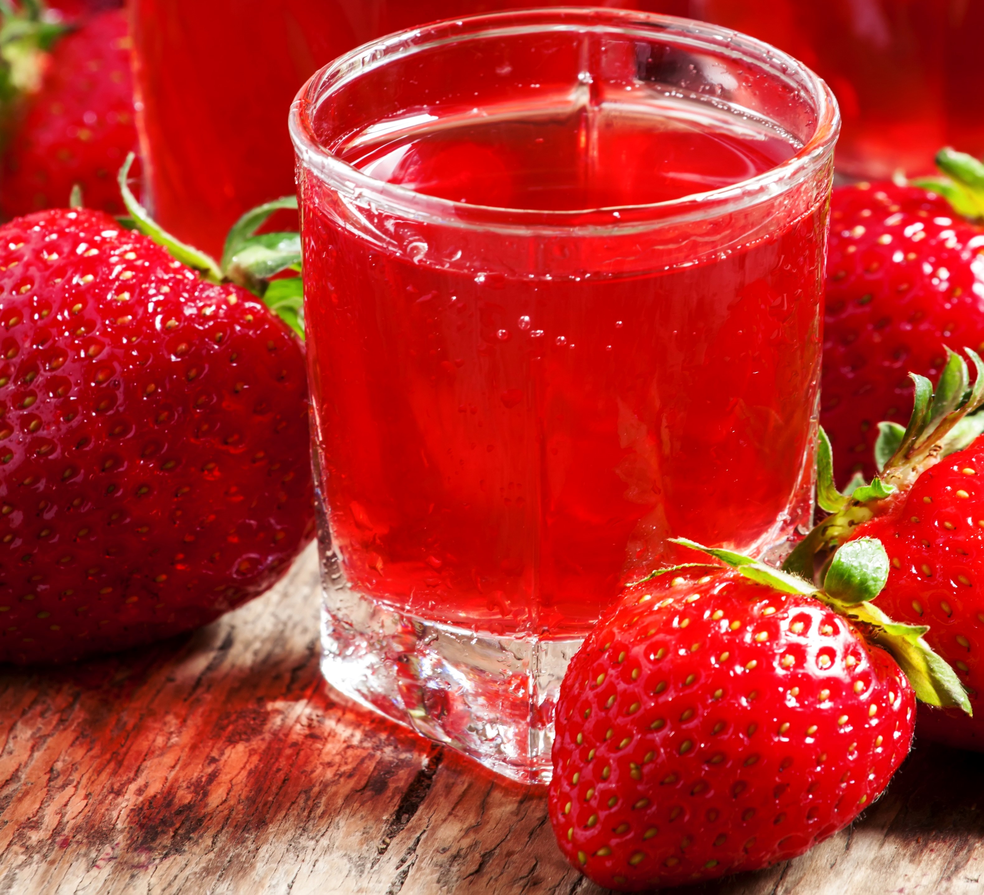 Strawberry juice in a glass with strawberries HD Wallpaper
