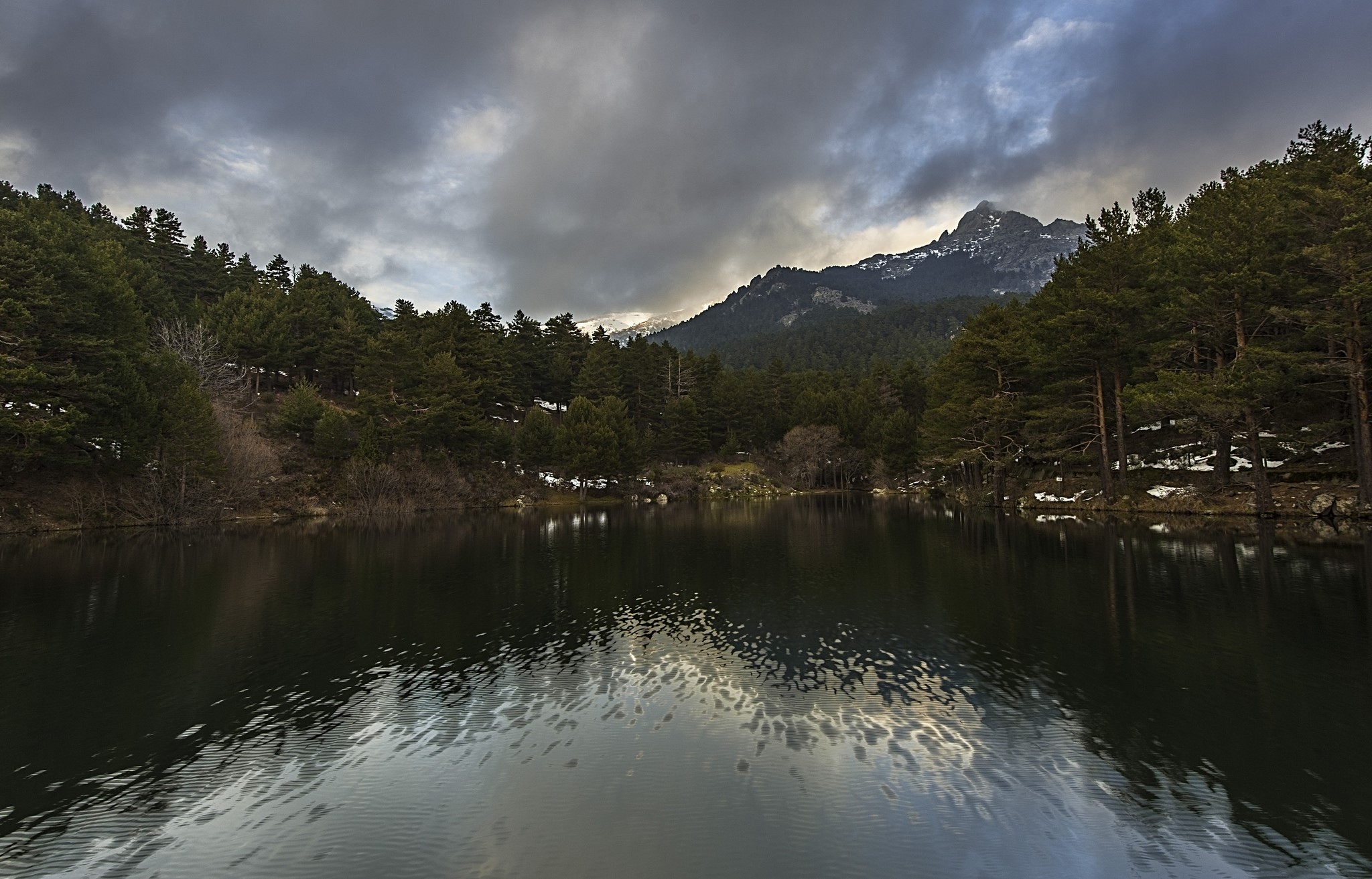 Lake and forest with mountains under thunderclouds in Spain HD Wallpaper