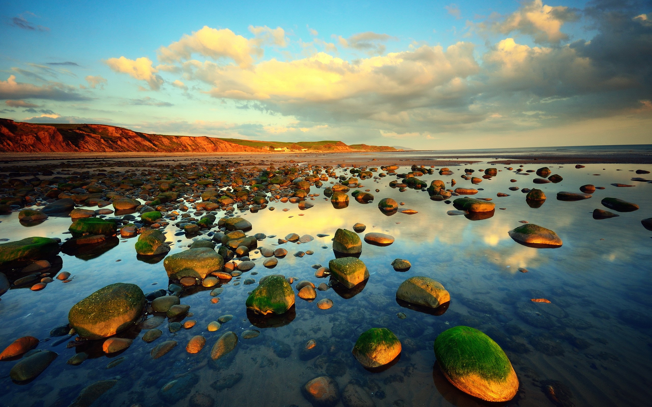 Rocky beach with tide pools and cliffs at sunset HD Wallpaper