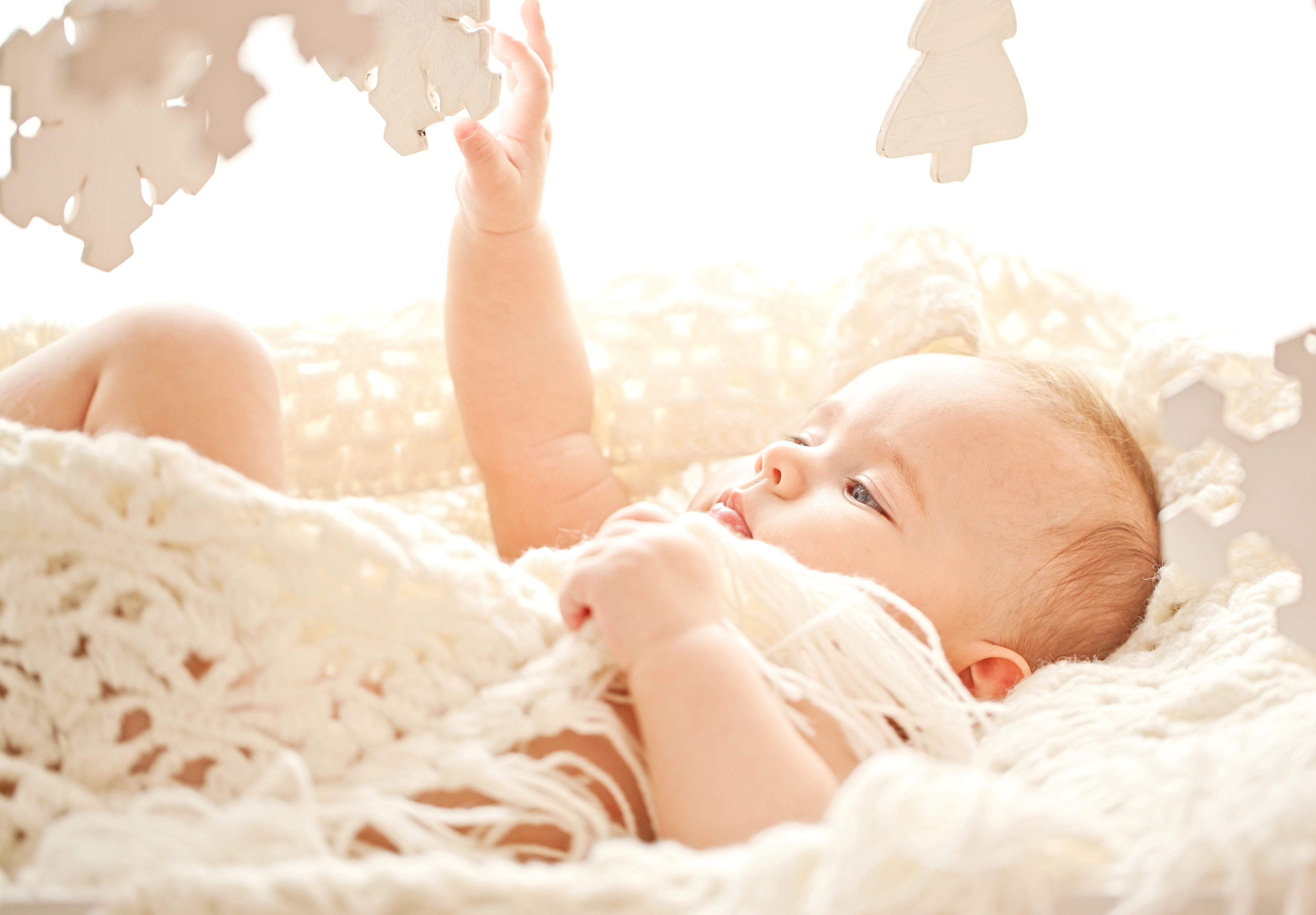 Baby reaching for a mobile HD Wallpaper