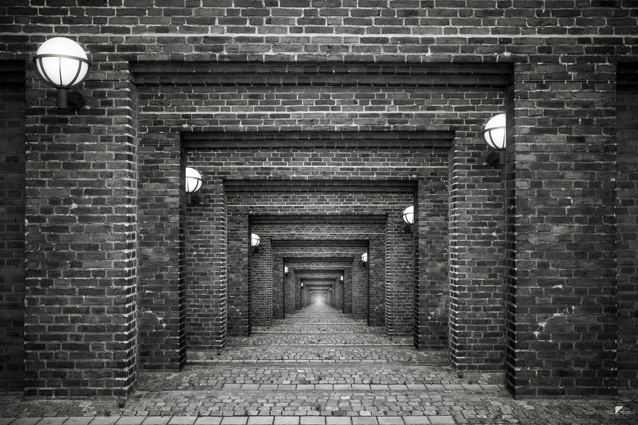 Brick hallway with repeating arches and lights HD Wallpaper
