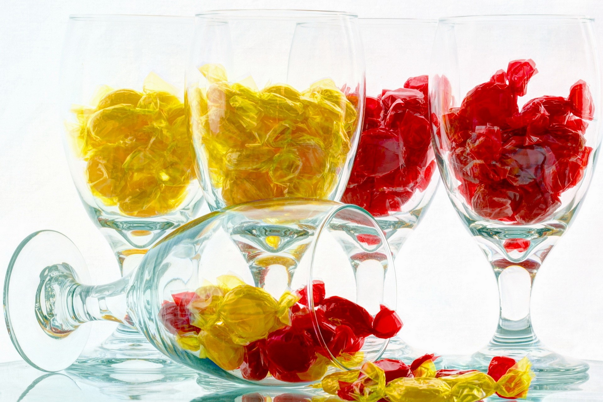 Red and yellow candies in wine glasses HD Wallpaper