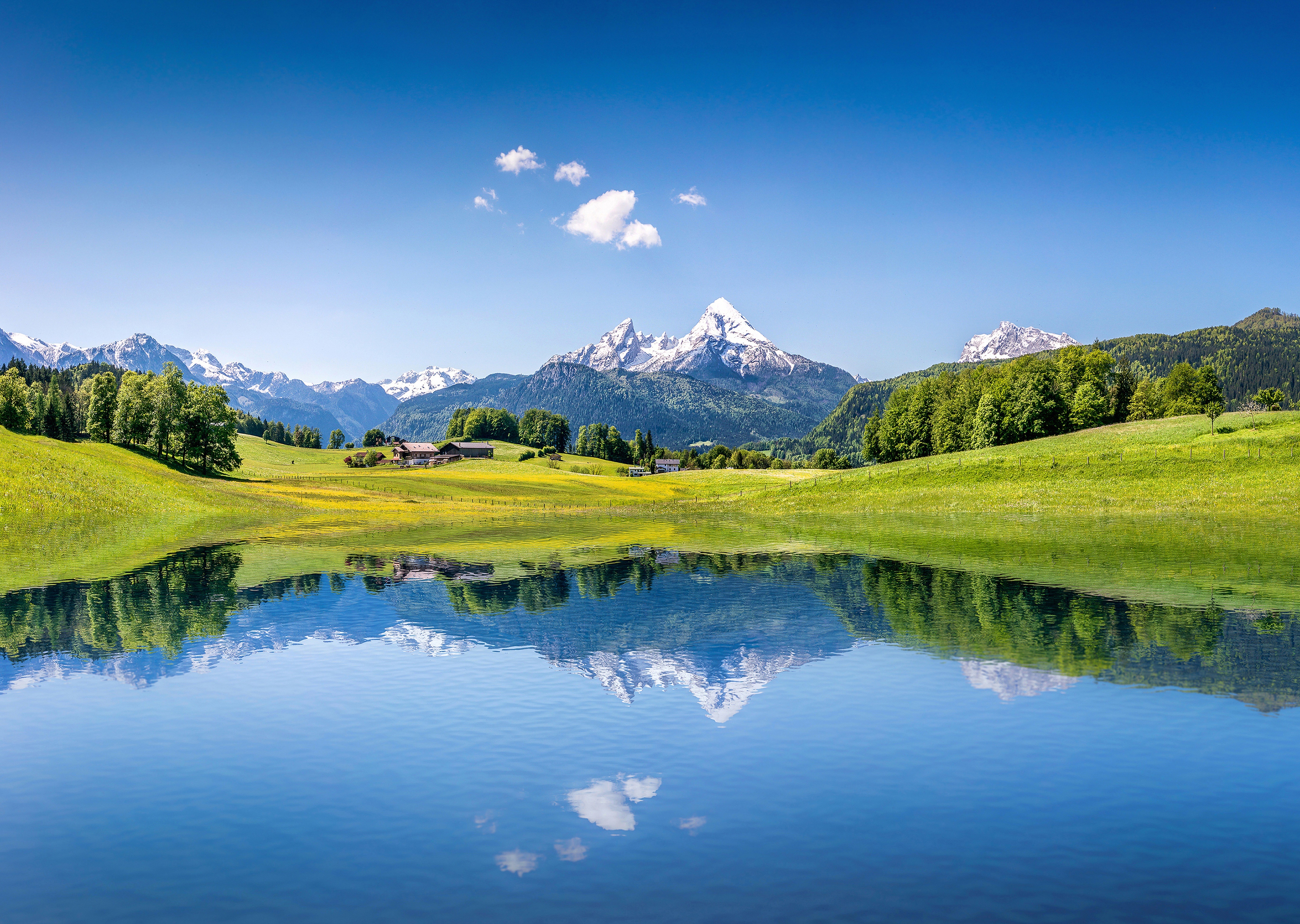 Mountains reflected in a lake with a blue sky HD Wallpaper
