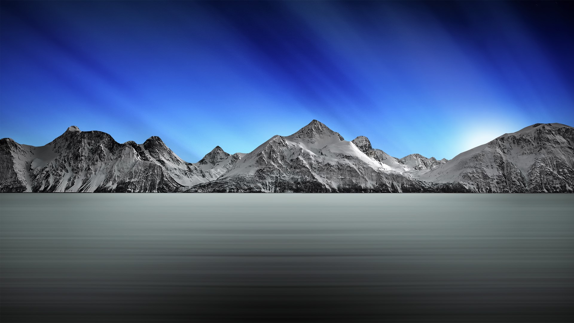 Snow-capped mountains under a blue sky HD Wallpaper