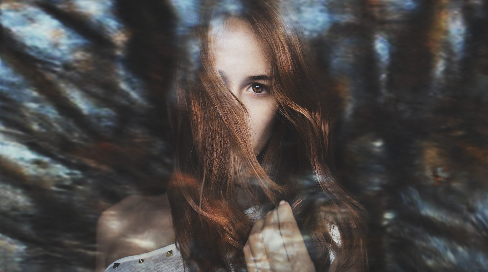 Woman with brown hair looking through her hair HD Wallpaper