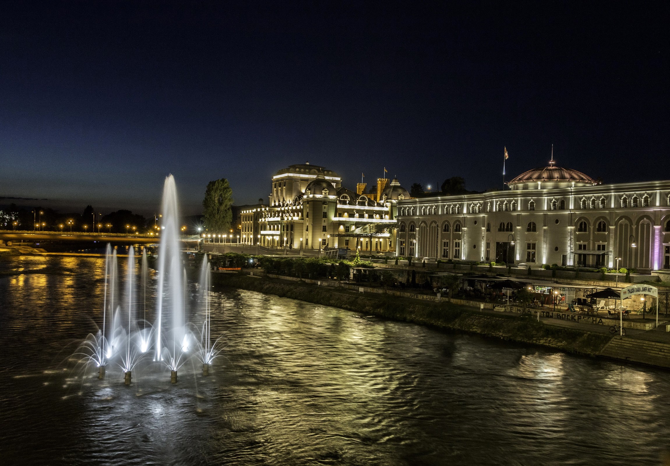 Fountains in front of illuminated buildings at night in Skopje, Macedonia HD Wallpaper