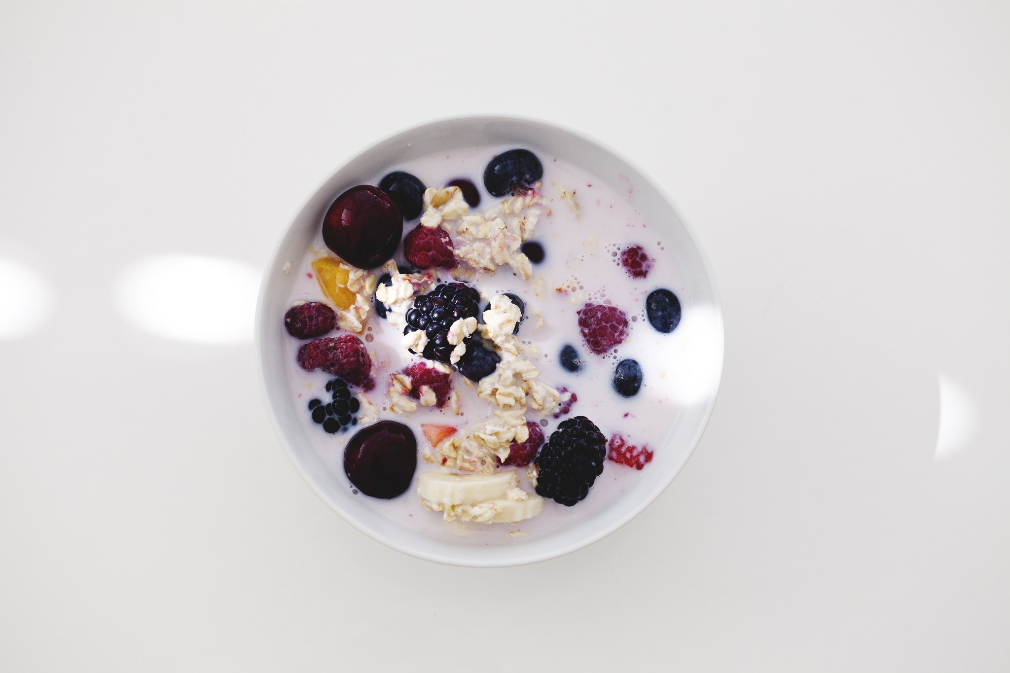 Bowl of muesli with berries and cherries HD Wallpaper